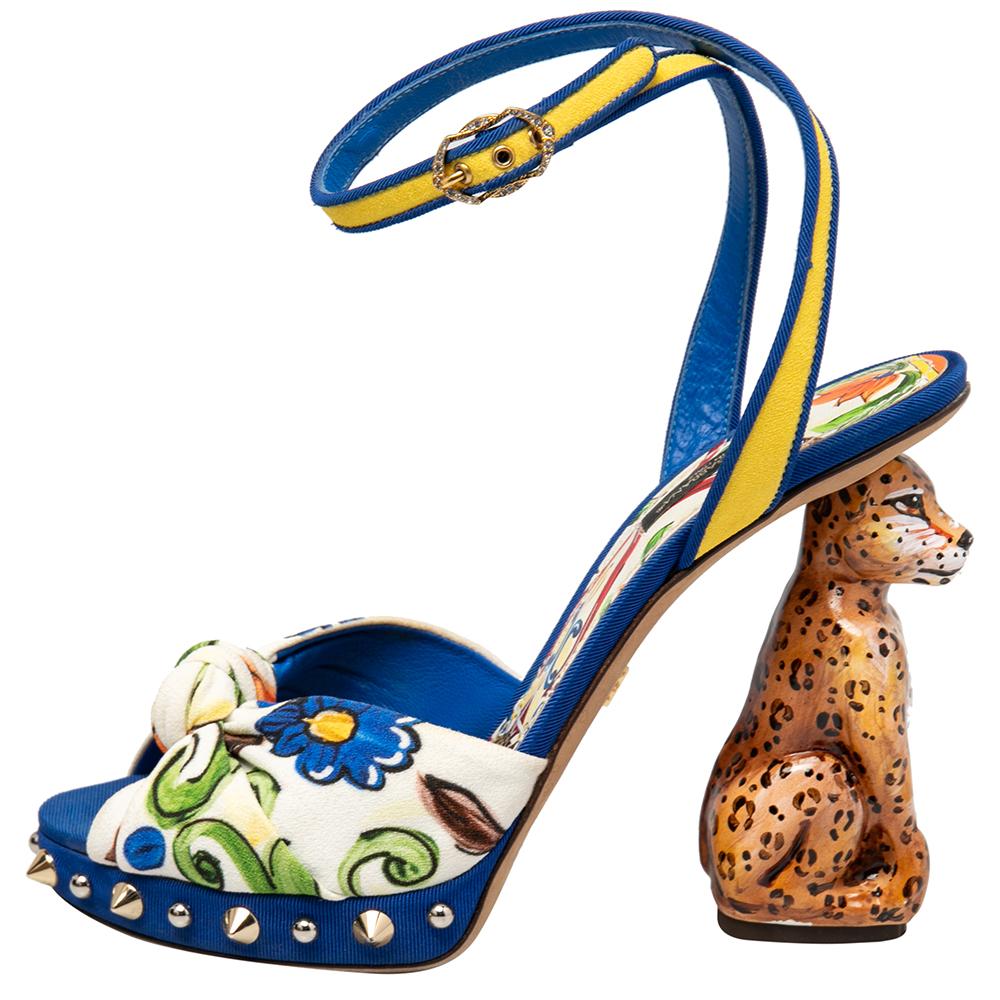 These sandals from Dolce&Gabbana have come straight from a shoe lover's dream. Designed using printed brocade fabric with open toes and ankle straps, the sandals are elevated on heels that are sculpted as a sitting leopard!