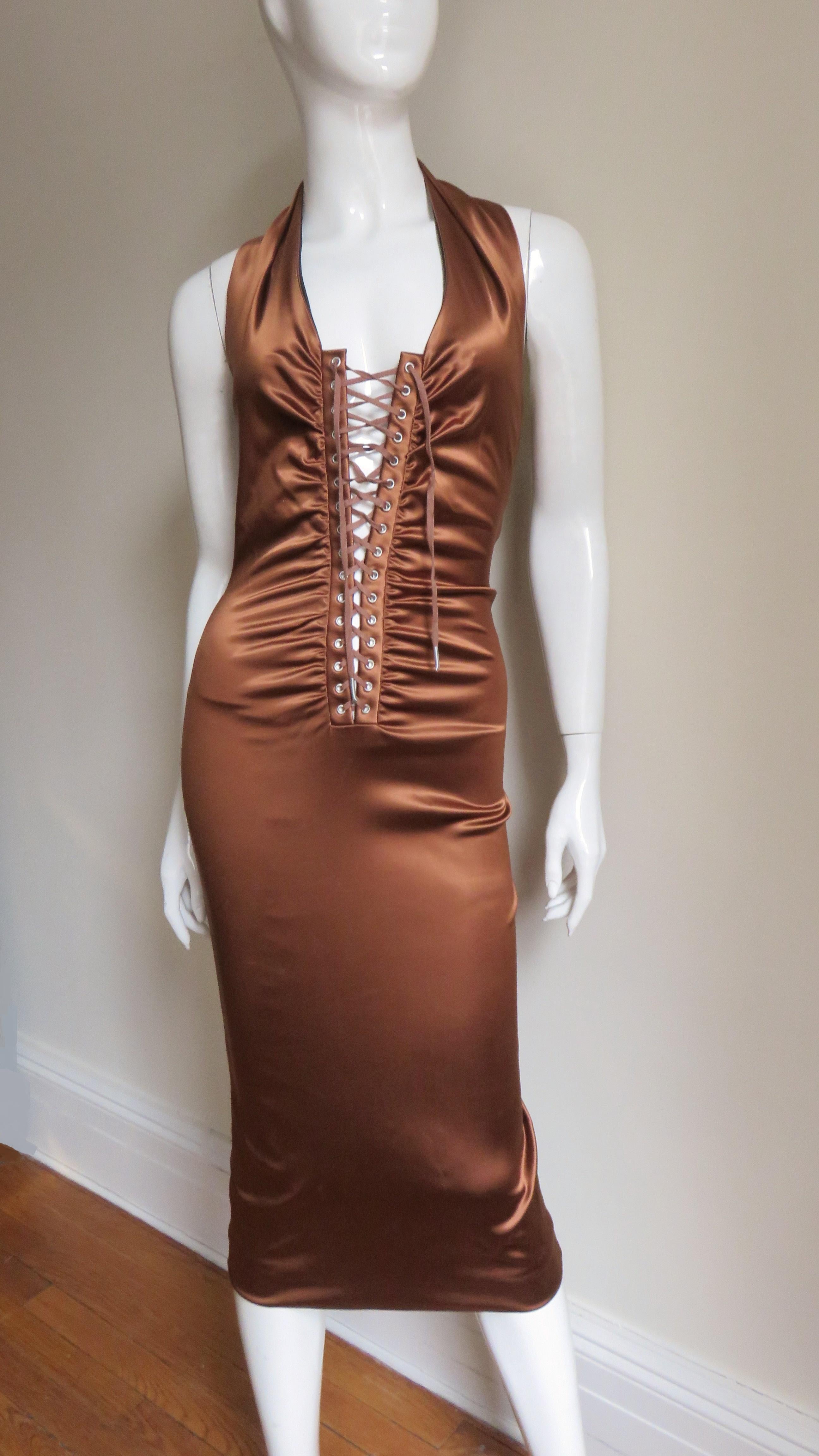 A fabulous rich bronze tan brown stretch silk halter dress from Dolce & Gabbana.  It has a scoop halter neckline with center front adjustable, lacing and subtle horizontal ruching front and back from bust through to the hips.  The dress has a