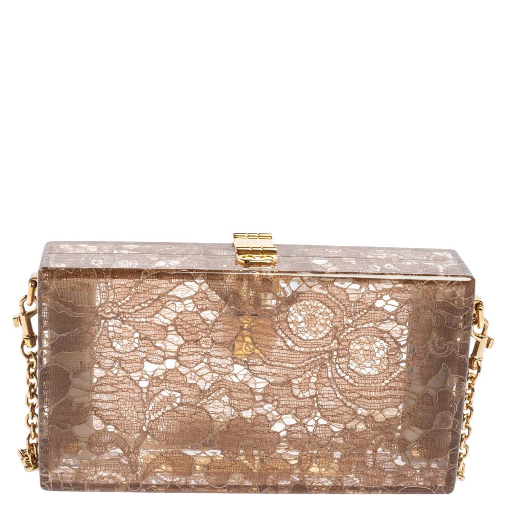 Crafted in Italy, it is made from quality acrylic and comes in a lovely shade of brown. The bag flaunts a lace pattern all over, a single chain in gold-tone, and a padlock that carries the brand logo as well as a floral motif. The bag opens to an