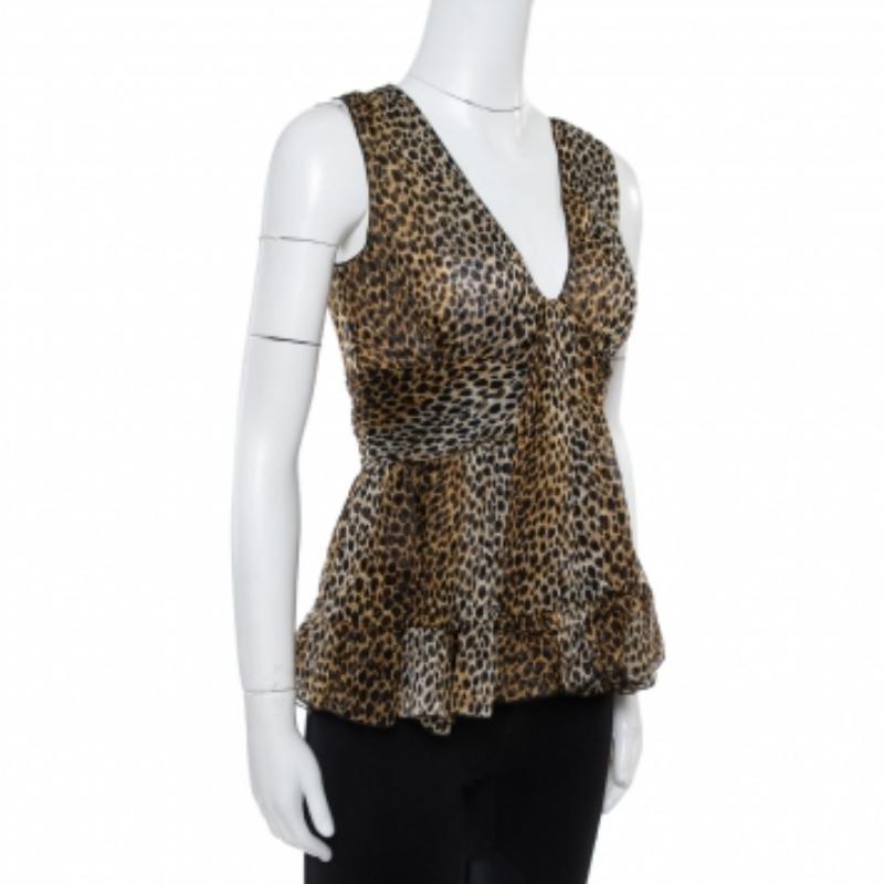 Exhibiting a chic style, this sleeveless Dolce & Gabbana top is a statement-making piece! The silk creation features an animal printed design that is enhanced with a deep V-neckline and ruffle details towards the bottom. It comes equipped with a zip