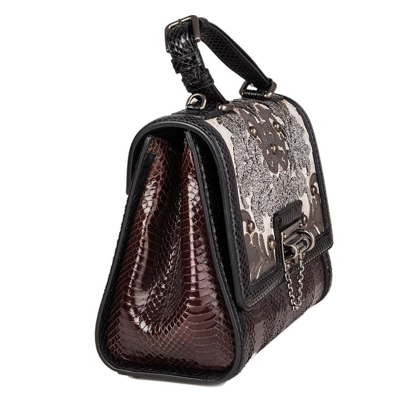 Dolce & Gabbana 'Monica Medium' bag in brown and black snakeskin with off-white and grey brocade with details in silver glazed leather. Detachable and adjustable shoulder strap. Opens with a bolt-lock on the front. Lined in black cototn with an open