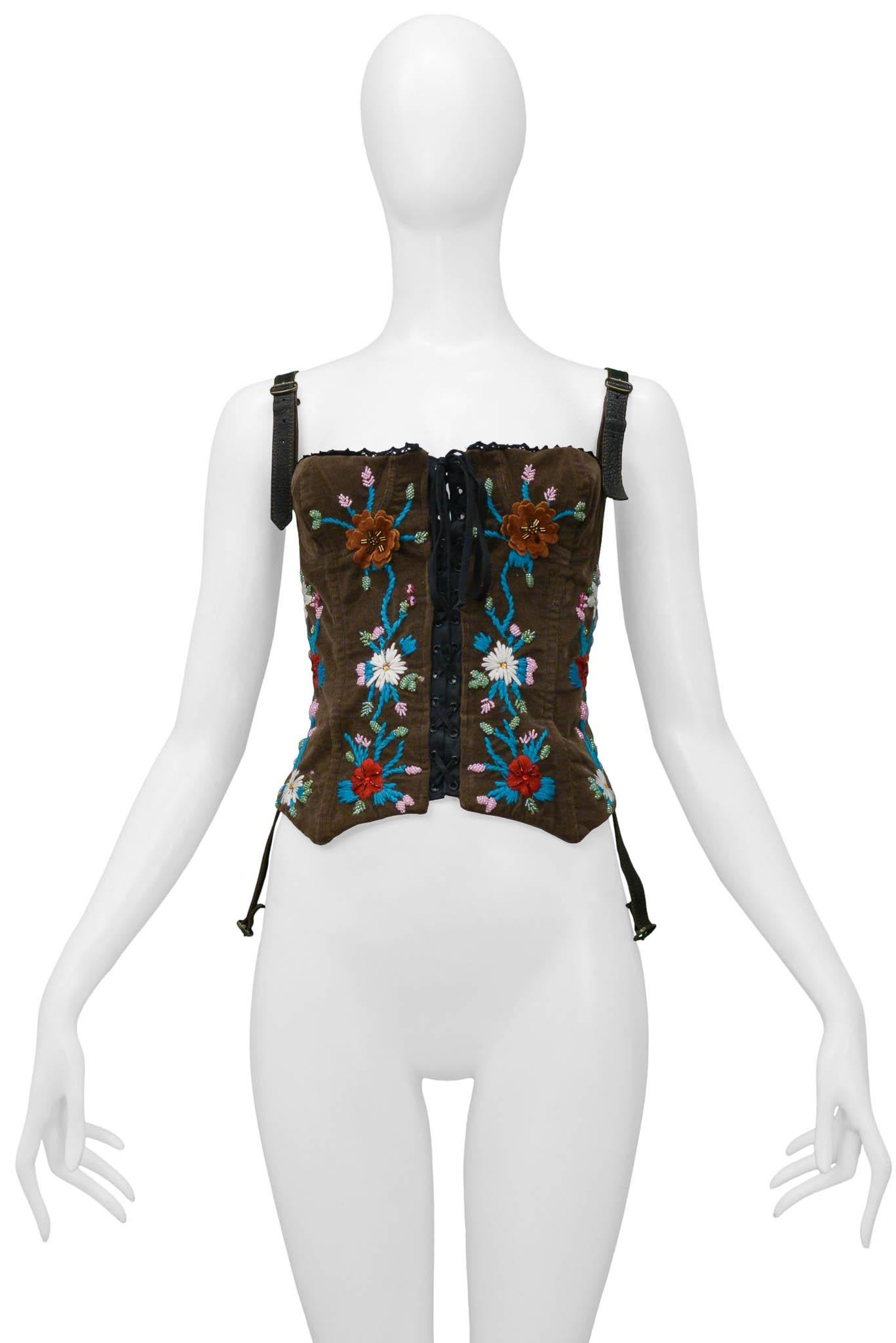 Resurrection Vintage is excited to offer a vintage Dolce & Gabbana brown corduroy corset top featuring floral embroidery and beading on the front, lace-up detailing on the front and back, and a hidden separating zipper at the side seam for easy
