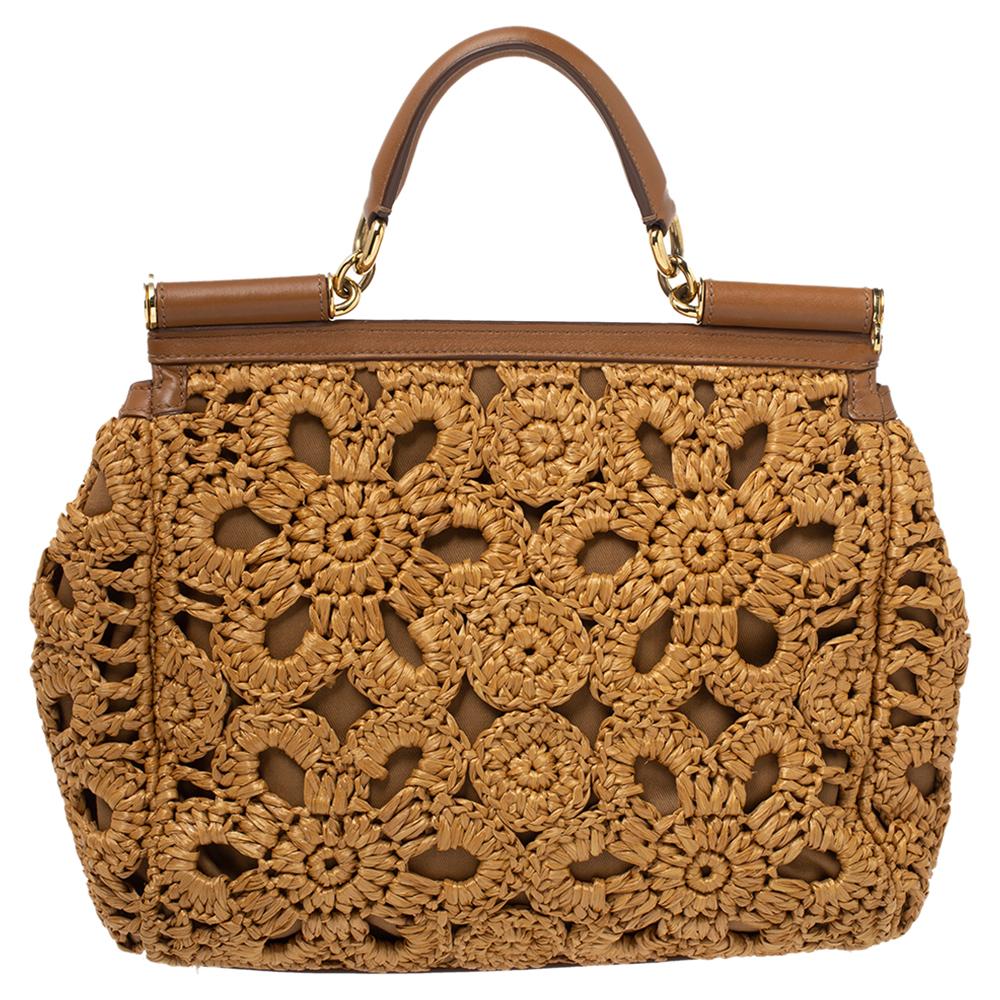 The Miss Sicily range of bags is one of the most celebrated creations from Dolce & Gabbana. This brown beauty beautifully embodies the spirit of extravagance and feminity that the Italian luxury brand carries. Crafted from crochet-knit raffia and