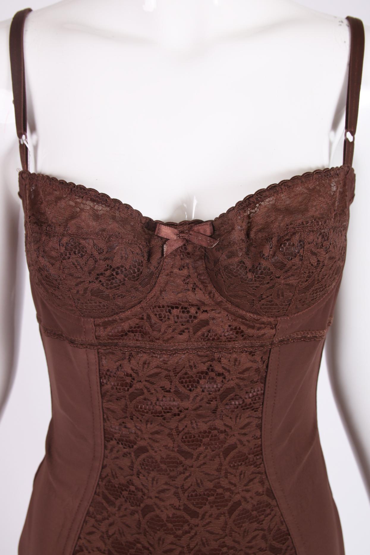 Dolce & Gabbana brown stretch bodysuit with lace at the bust and center front panel. Bra straps are sizable, and there are hook and eye closures at the crotch. Size tag 44. Fabric is a nylon, elastane blend. In excellent condition, with original