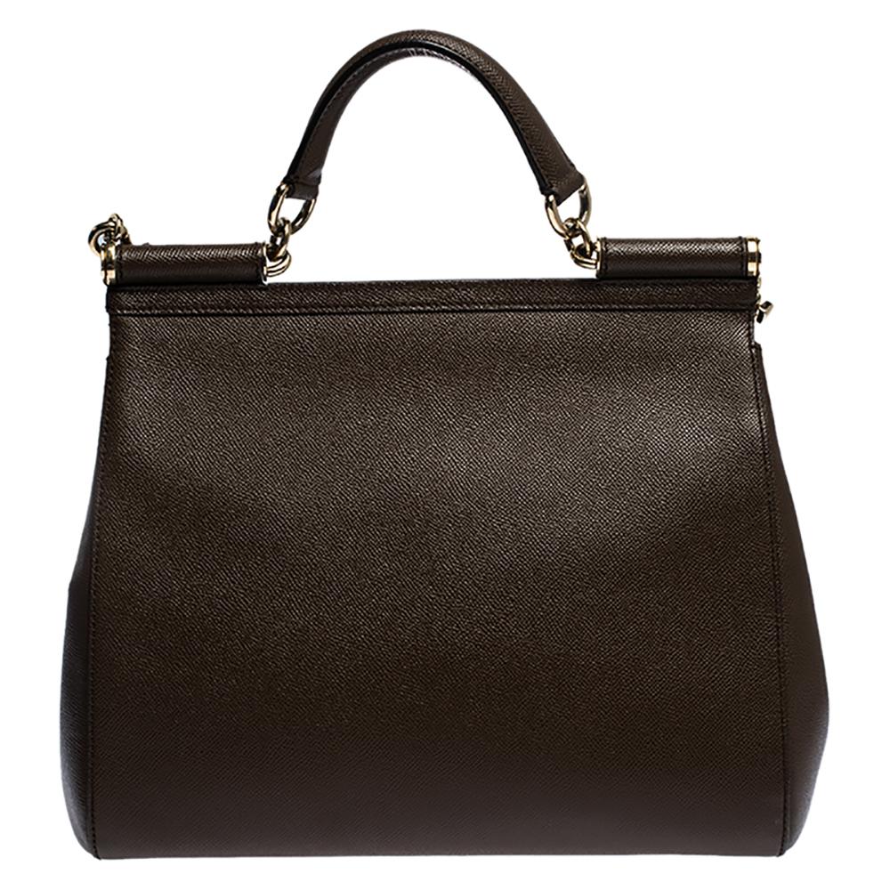 This gorgeous brown Miss Sicily bag from Dolce & Gabbana is a handbag coveted by women around the world. It has a well-designed exterior and a flap that opens to a compartment with fabric lining and enough space to fit your essentials. The bag comes
