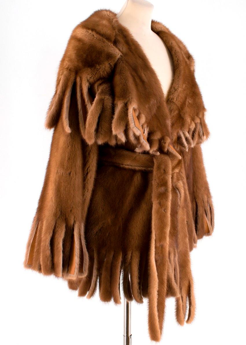 Dolce & Gabbana Brown Mink Fur Fringe Cape Wrap Coat fastened with concealed buttons featuring long sleeves and side pockets. 

- Fringed trims
- Leather lining
- Made in Italy

Please note, these items are pre-owned and may show signs of being