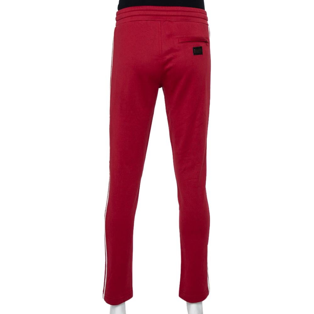 A work-from-home or stay-at-home fashion staple, sweat pants are the ultimate comfort clothing to wear these days. This pair is by Dolce & Gabbana. Made from cotton, the burgundy pair features contrast trims on the sides, pockets, and a comfortable