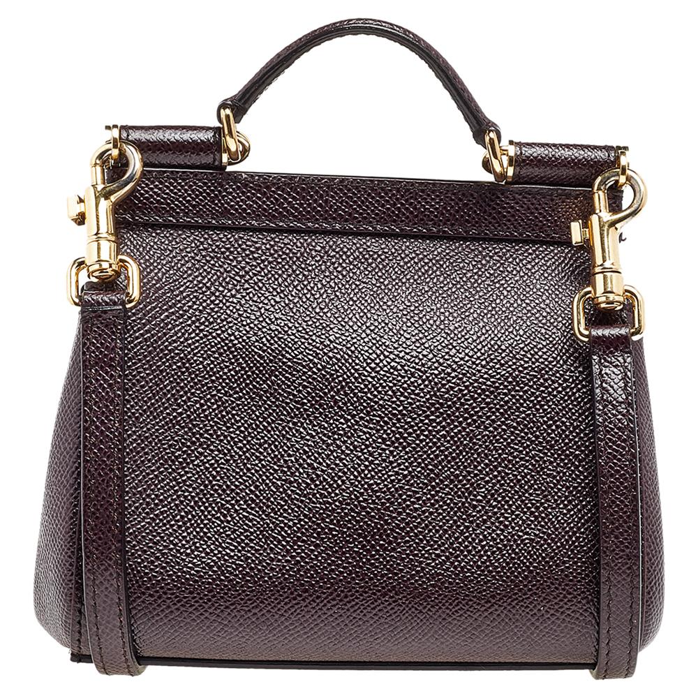 This mini Miss Sicily is a sized-down version of the iconic tote bag from Dolce & Gabbana. Made of burgundy leather, the bag has a signature top handle and a flap with the brand plaque. A shoulder strap allows crossbody style.

Includes: Original