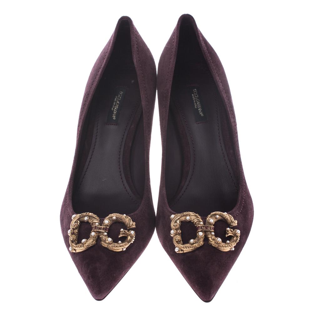 Walk with grace and confidence in these pumps by Dolce & Gabbana. Styled in a burgundy shade, with embellished DG logo applique on the pointed toes, and leather insoles to provide comfort, these suede DG Amore pumps will never fail to lift your