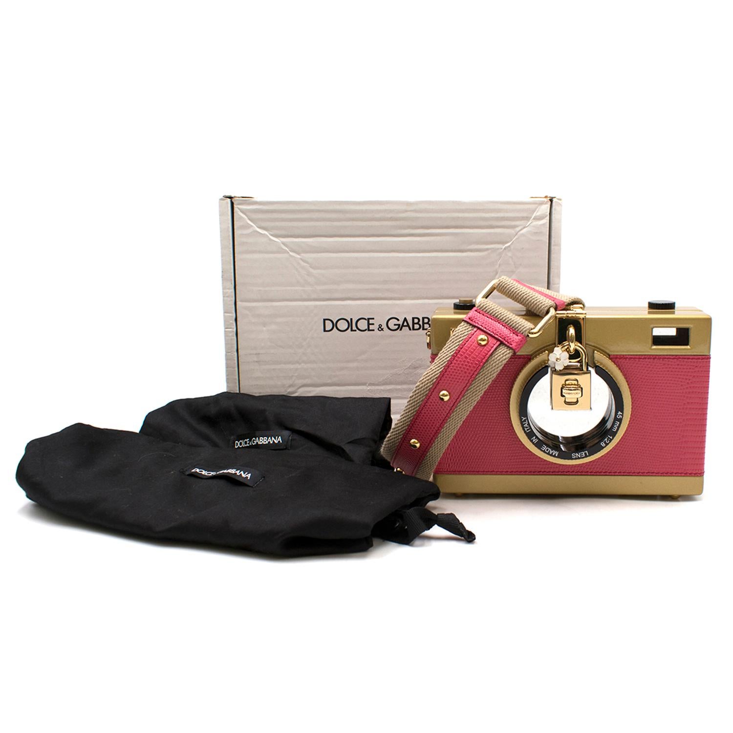 Dolce & Gabbana Pink Camera Bag

-Camera clutch bag with padlock clasp
-Gold toned hardware
-Black velvet lining with one slot
-Adjustable shoulder strap with gold toned studs
-Gold toned plates embossed with Dolce & Gabbana

Size: One