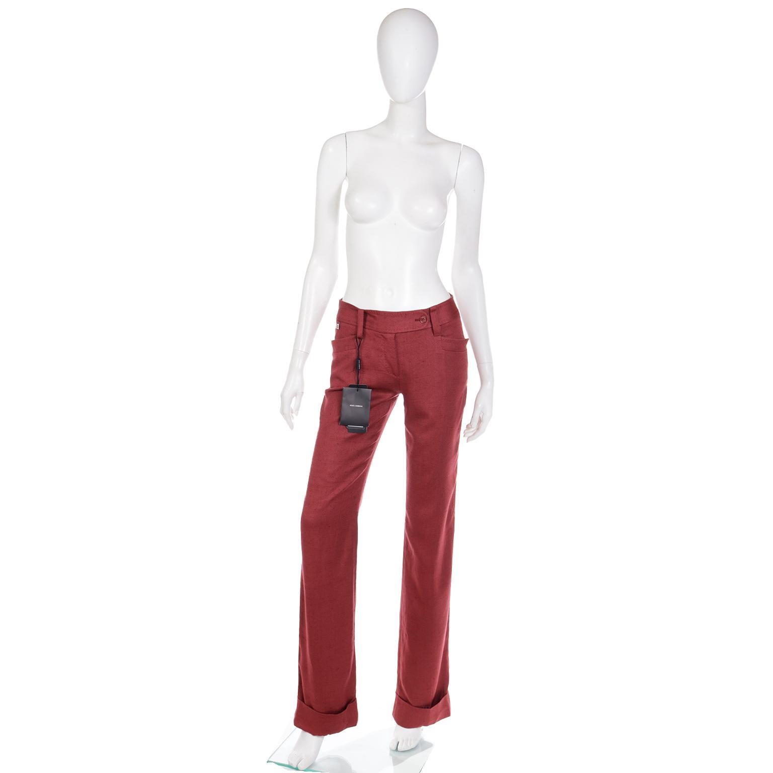 This is a beautiful pair of Dolce & Gabbana cardinal red trousers in a luxe 100% silk denim or twill weave. These pants are deadstock with their original tags attached and were never worn. The pants have front side slit pockets and two back pockets