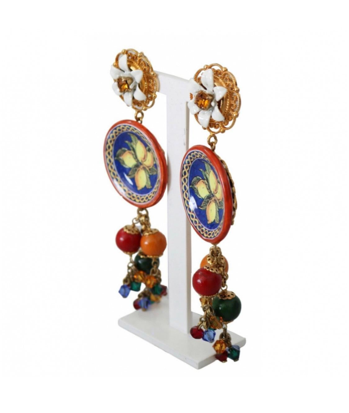 Gorgeous brand new with tags,
100% Authentic Dolce &

Gabbana Carretto lemon drop earrings.
Polished yellow golden brass hardware
with resin forms flower and lemon
motifs.

Model: Clip-on, drop

Motive: Lemon

Material: Brass, glass, resin

Color: