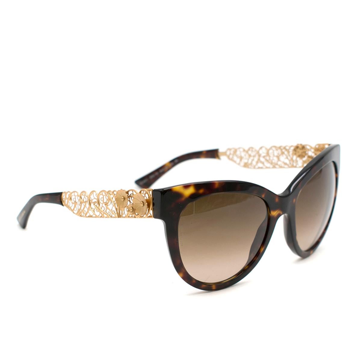 Dolce & Gabbana Cat-Eye Sunglasses With Golden Filigree Arms

- Frame Color: Havana - Gold 
-Lens Color: Brown Shaded -Dolce & Gabbana Logo On Lens
-Made in Italy

Please note, these items are pre-owned and may show some signs of storage, even when