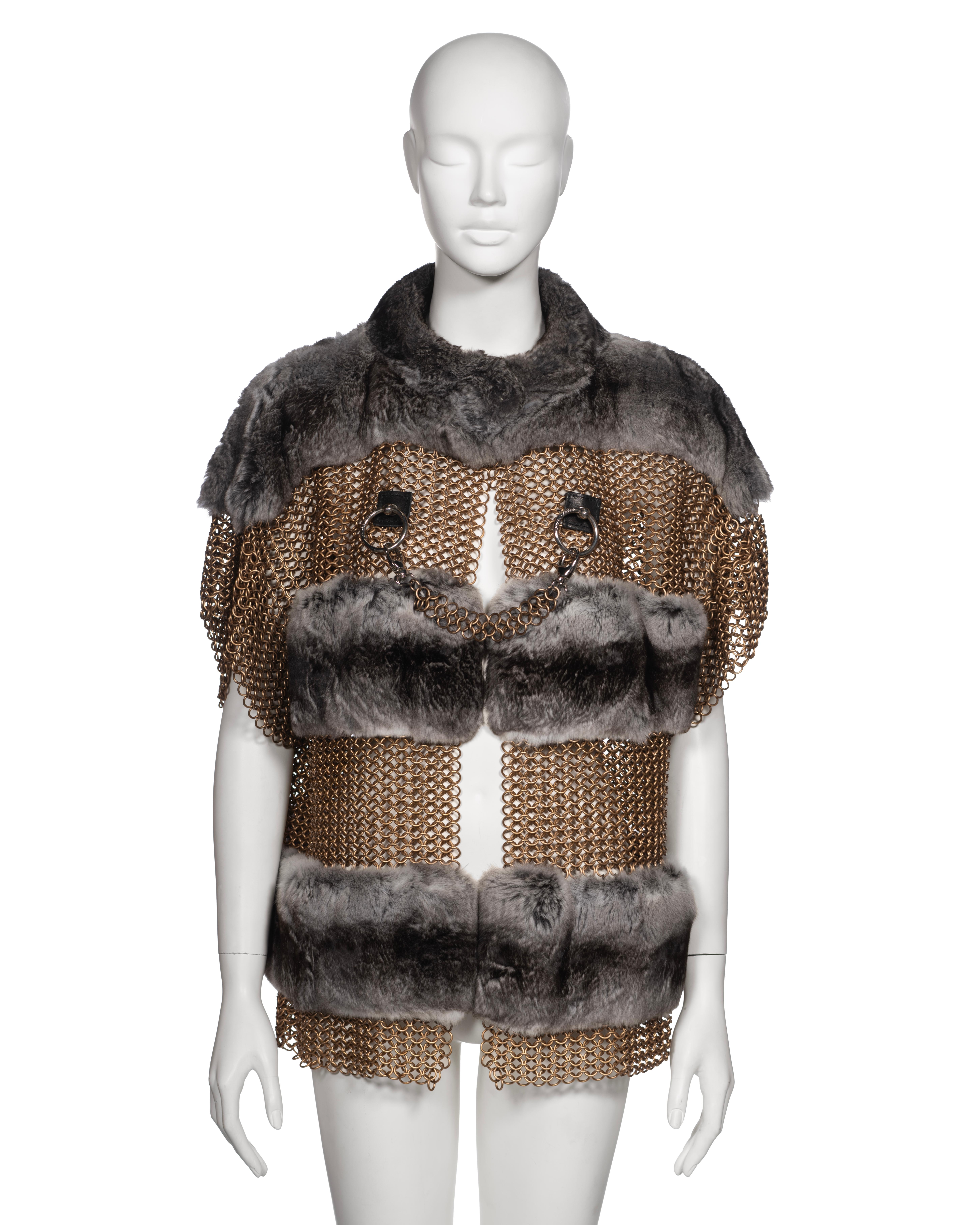 ▪ Archival Dolce & Gabbana Chainmail and Fur Runway Jacket 
▪ Creative Director: Domenico Dolce and Stefano Gabbana 
▪ Spring-Summer 2003
▪ Sold by One of a Kind Archive
▪ Comprised of bronze-tone metal chainmail and chinchilla fur bands
▪ Featuring