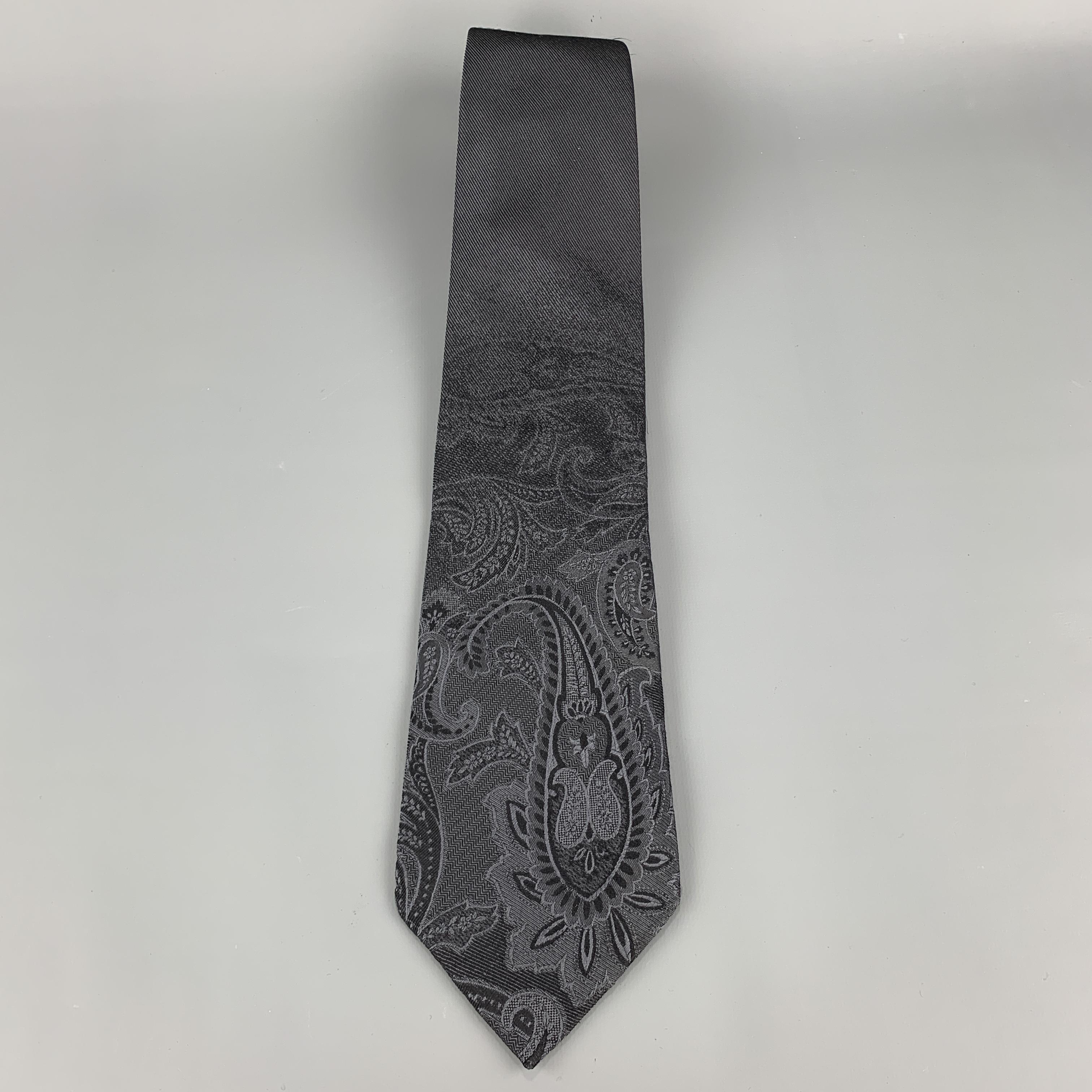 DOLCE & GABBANA necktie comes in charcoal silk twill with all over ombre paisley print. Made in Italy.

Very Good Pre-Owned Condition.

Width: 3.75 in.