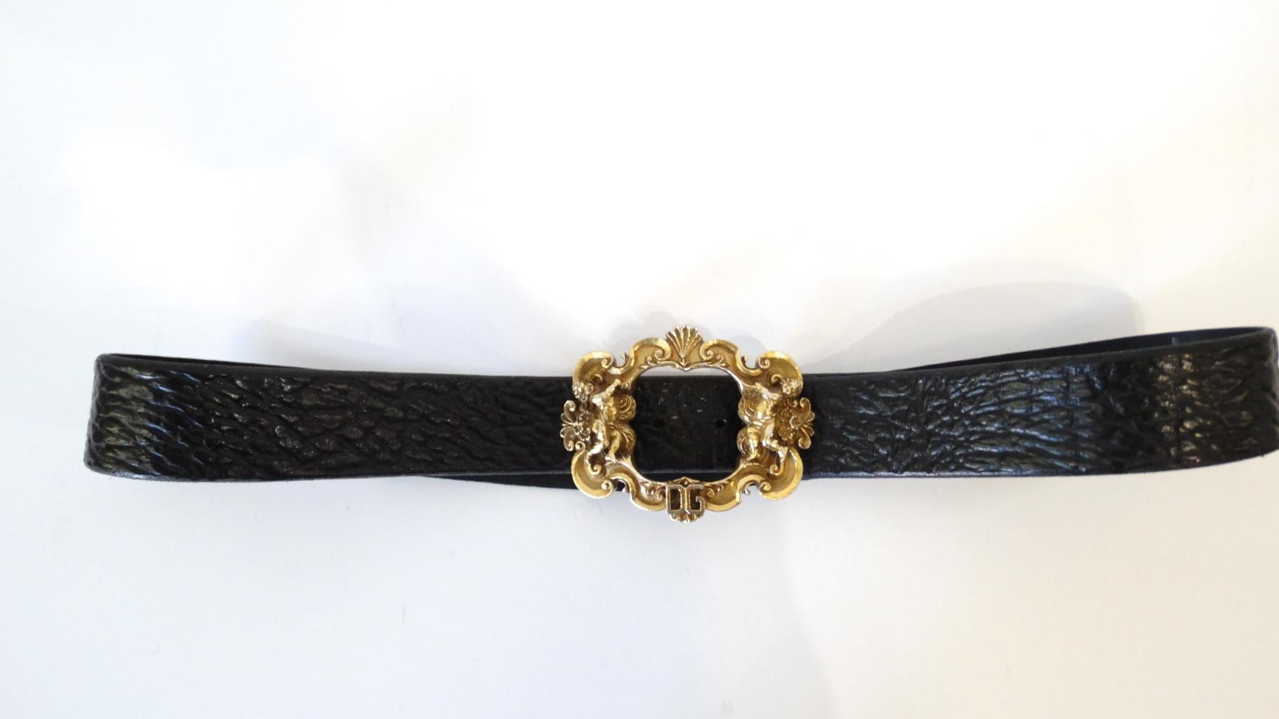 For the love of detail! This amazing Dolce & Gabbana belt is made of black textured leather. Features an amazing detailed Byzantine style statement buckle which is decorated with Cherub Angels and a DG at the bottom. Signed Dolce & Gabbana. Made in