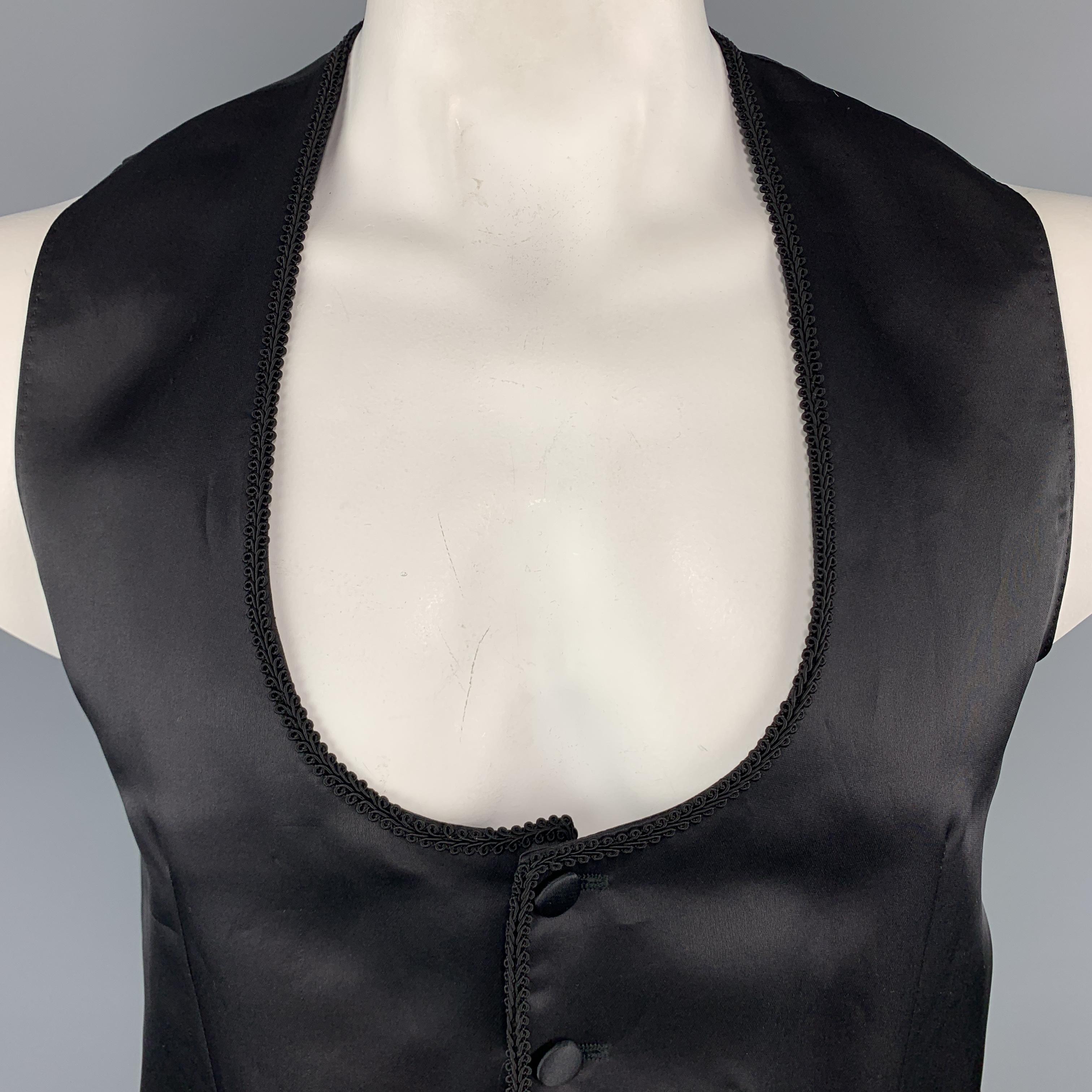 DOLCE & GABBANA Vest comes in a black tone in a solid silk / wool material, with a round collar, a trim, covered buttons, slit pockets, single breasted, and a belt at back. Made in Italy.

Excellent Pre-Owned Condition.
Marked: IT