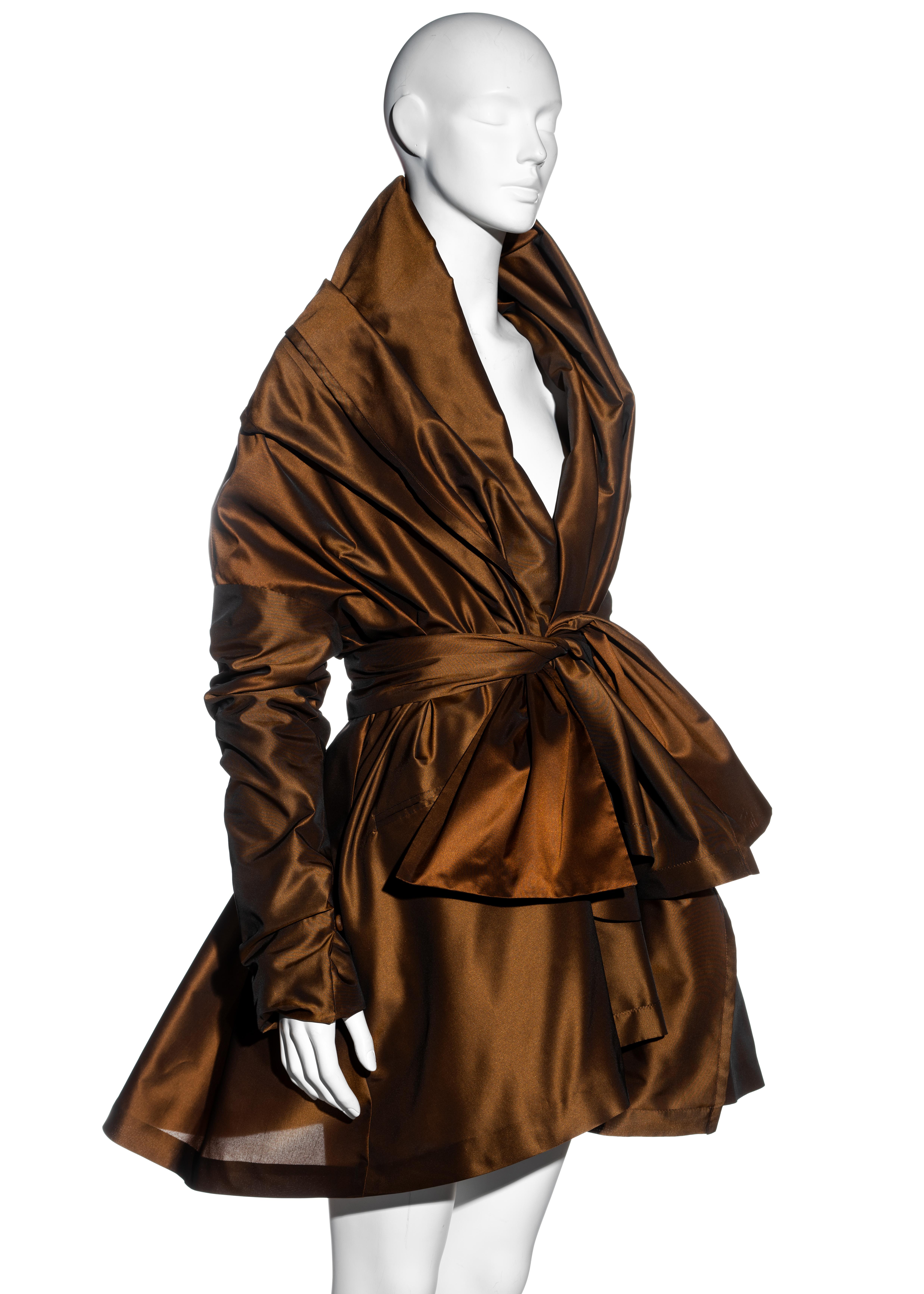 ▪ Dolce & Gabbana copper taffeta evening coat dress
▪ Voluminous shape 
▪ Constructed with two-layered coats attached at the sleeves 
▪ Full structured skirt 
▪ Matching belt accentuating the waist
▪ A Large collar which can be styled off-shoulder