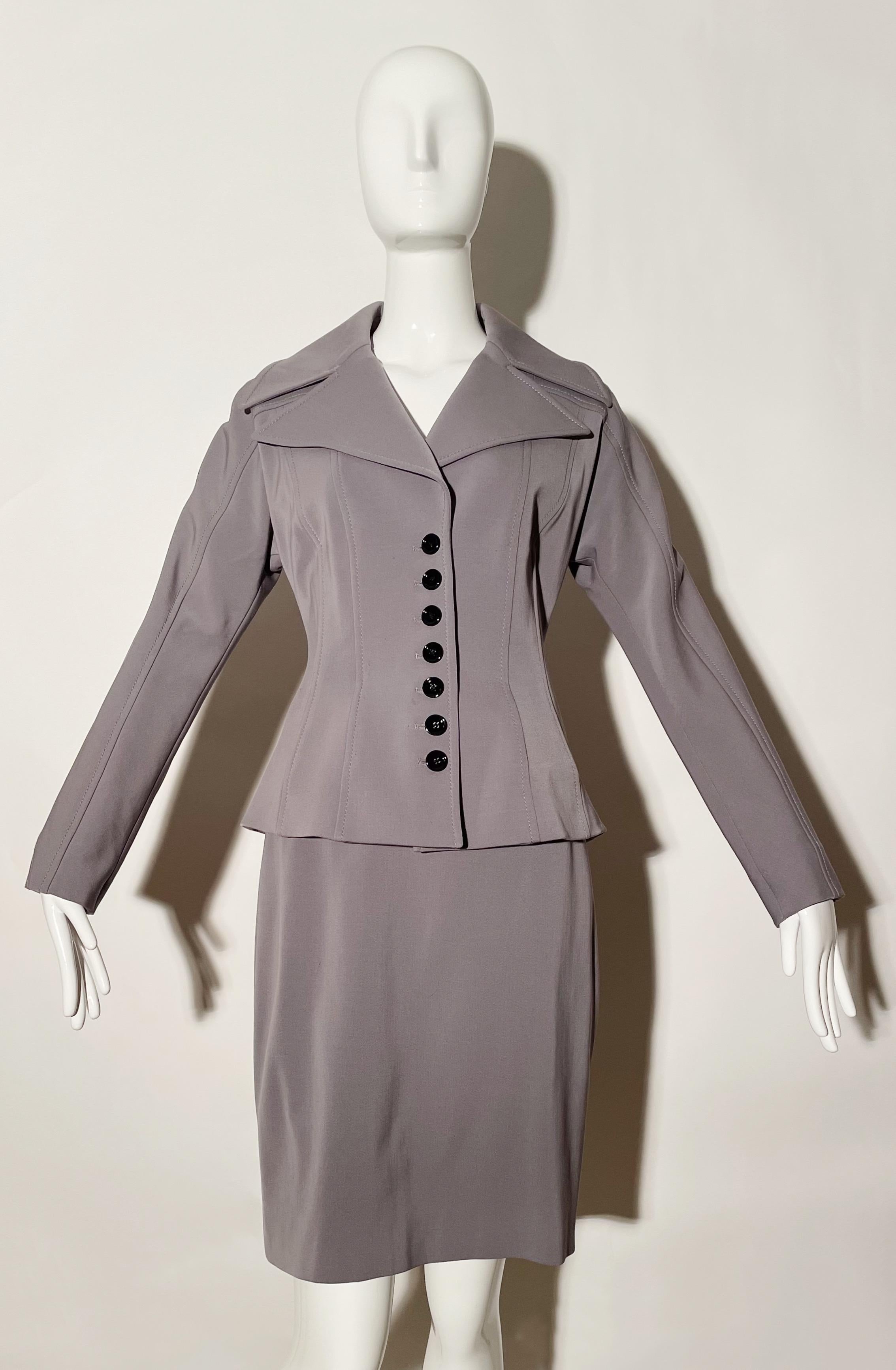 Grey skirt suit. Corset piping detail. Front buttons. Large collar. Stretchy. Made in Italy. 
*Condition: Excellent vintage condition. Visible Flaw ( as pictured) 

Measurements Taken Laying Flat (inches)—
Shoulder to Shoulder: 17 in.
Sleeve Length: