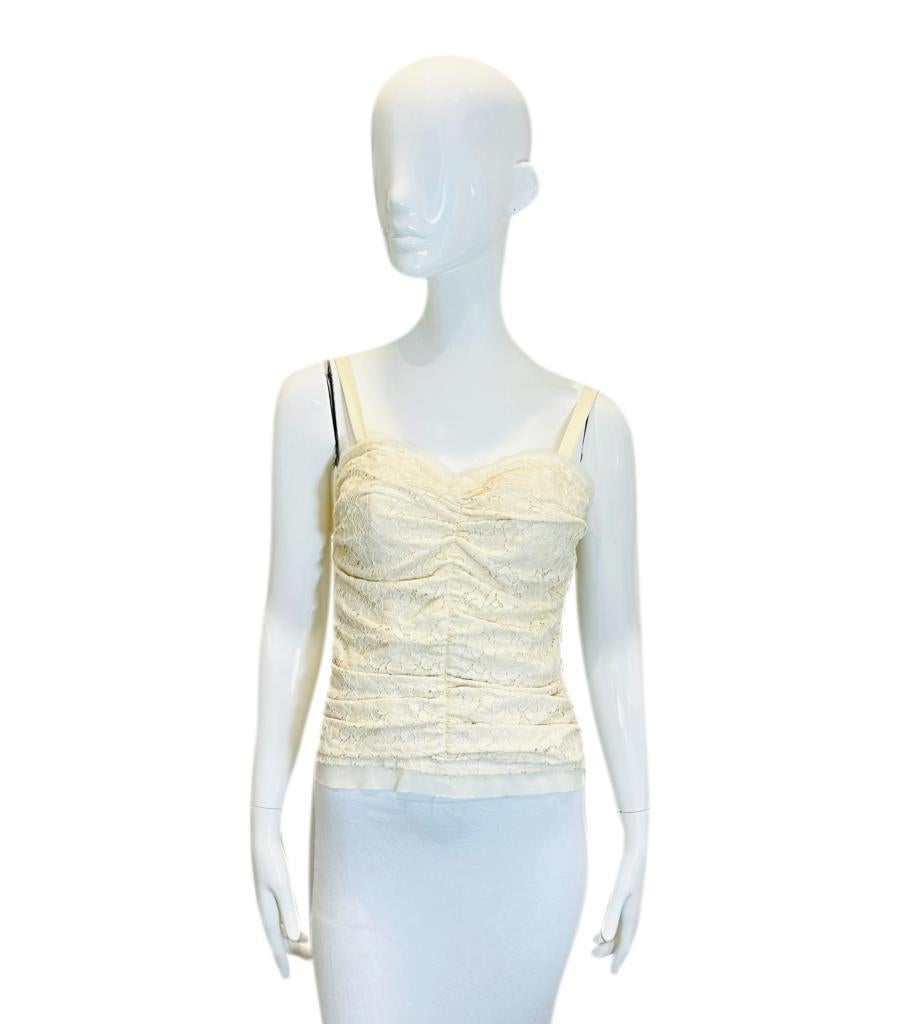 Dolce & Gabbana Cotton Lace Corset

Ivory sleeveless corset top crafted from ruched floral lace.

Detailed with white lace trims, spaghetti straps and 'Dolce & Gabbana' engraved zipper closure to rear.

Size – 42IT

Condition – Very
