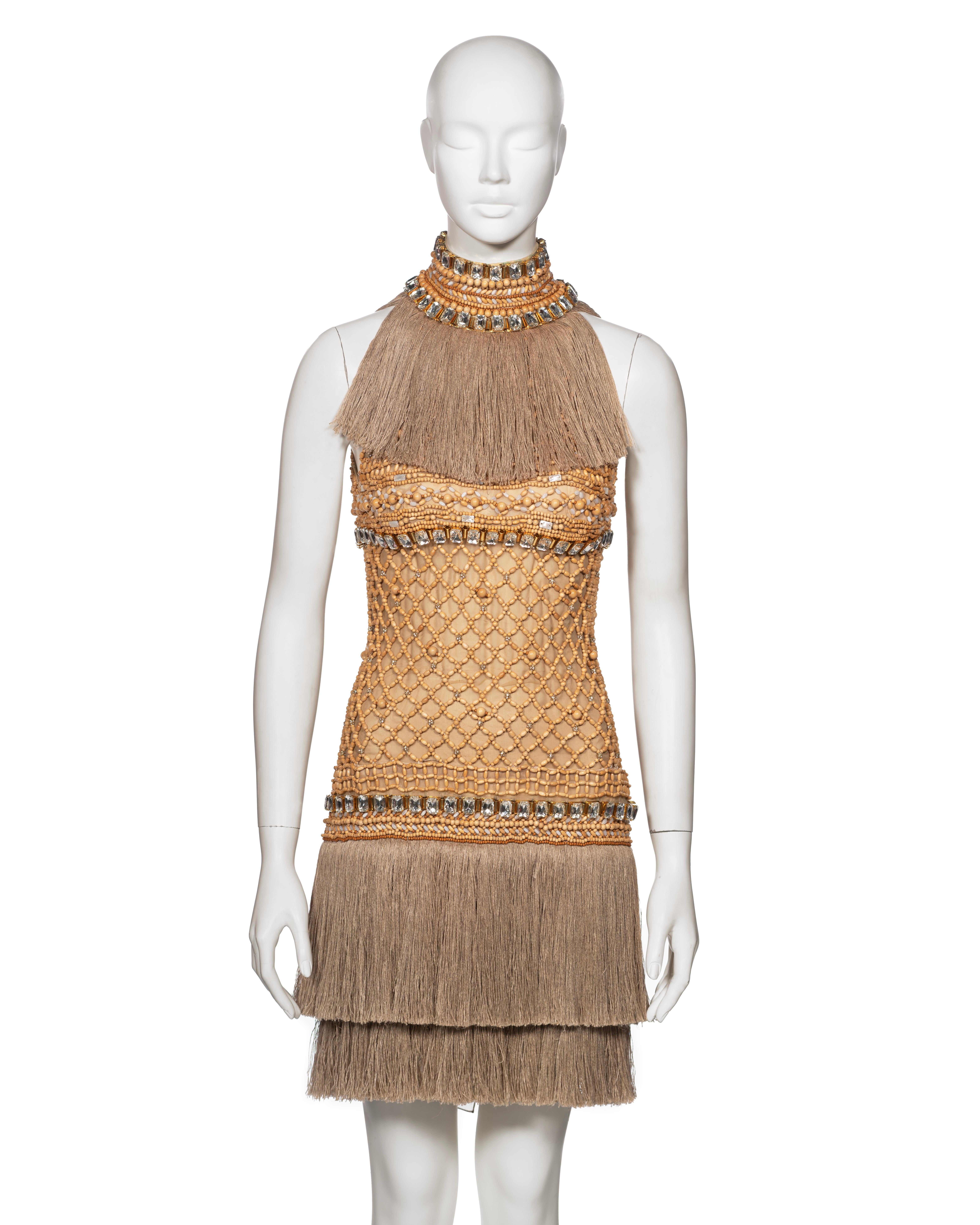 Dolce & Gabbana couture evening dress, originally made to order. The bodice and halter neck are intricately embellished with wooden beads, forming a lattice pattern. The dress is designed to fit closely to the body, accentuating the figure, and is
