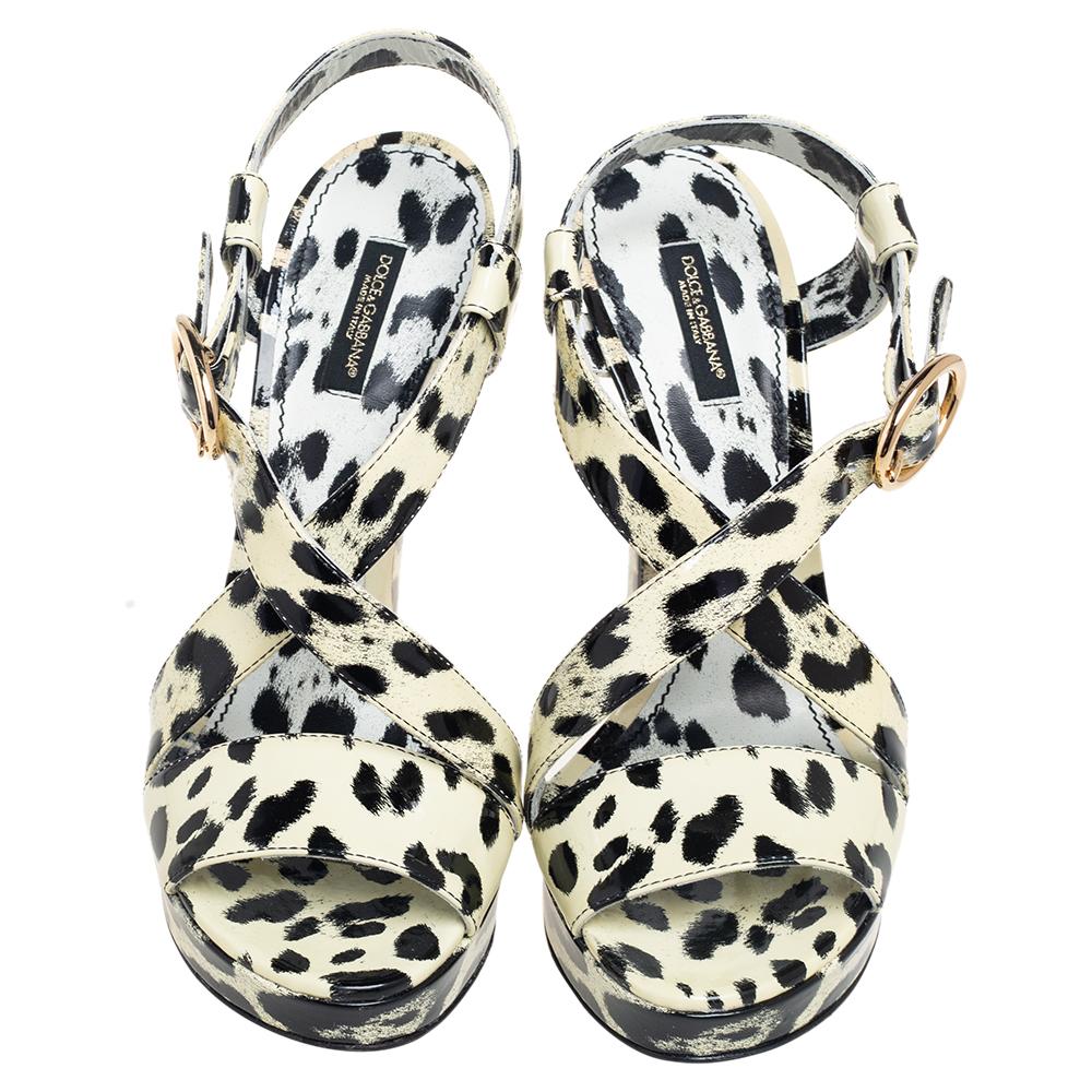 Dolce & Gabbana give their signature motifs a classic edge with these chic sandals. Crafted from luxurious patent leather, these sandals are presented in a cream and black animal print design and feature an open toe, a branded insole, an ankle strap