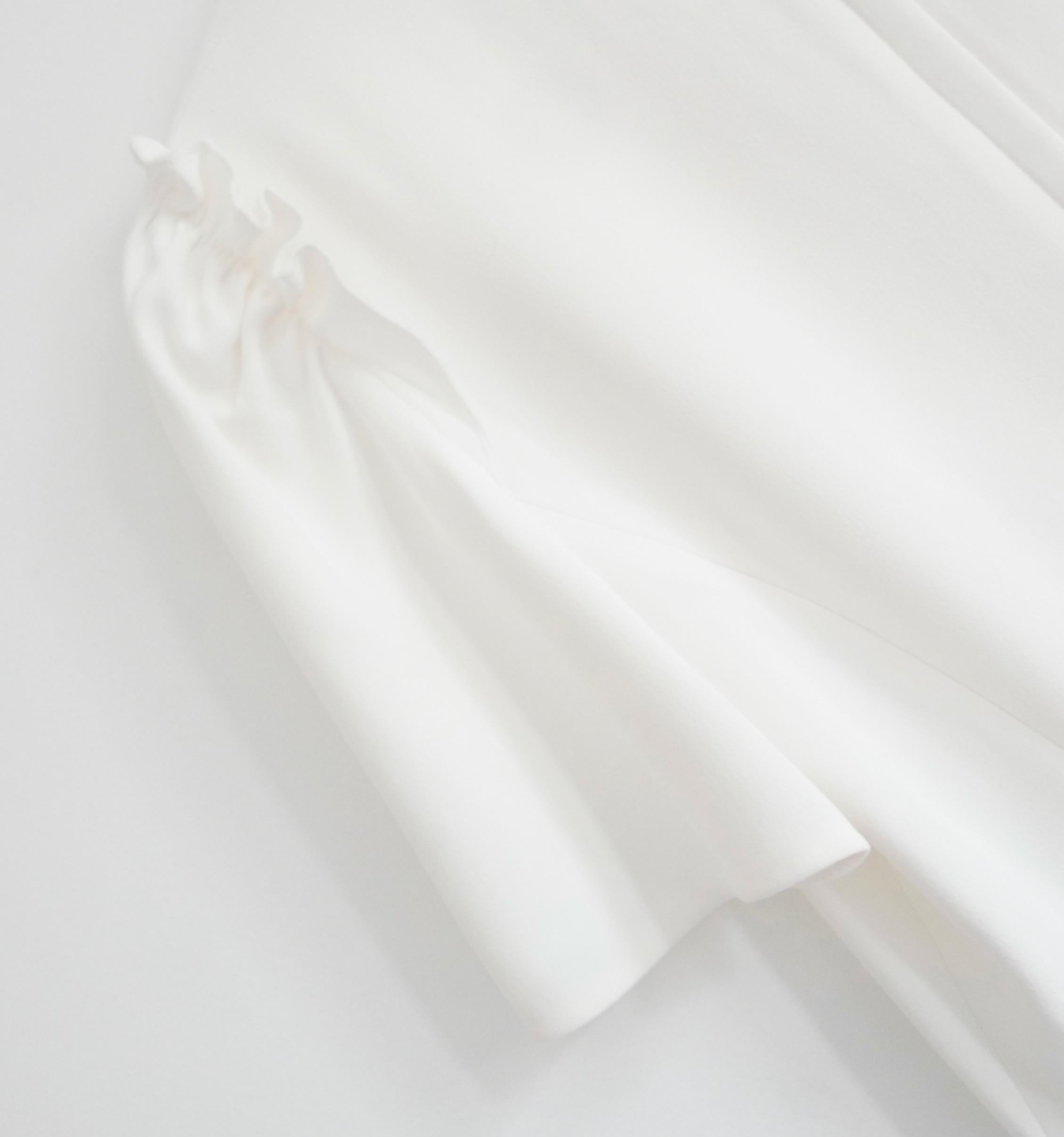 Classic Dolce & Gabbana cream crepe top. New with tags. Made from soft cream viscose mix crepe, it has a gently tailored cut with pretty frilled shoulders, short sleeves and concealed zip to back. Size IT40/UK8. Measures approx - bust 34”, waist 30”
