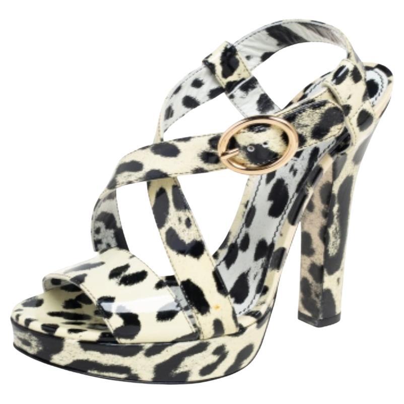 Dolce & Gabbana give their signature motifs a classic edge with these chic sandals. Crafted from luxurious patent leather, these sandals are presented in a cream and black animal print design and feature an open toe, a branded insole, an ankle strap