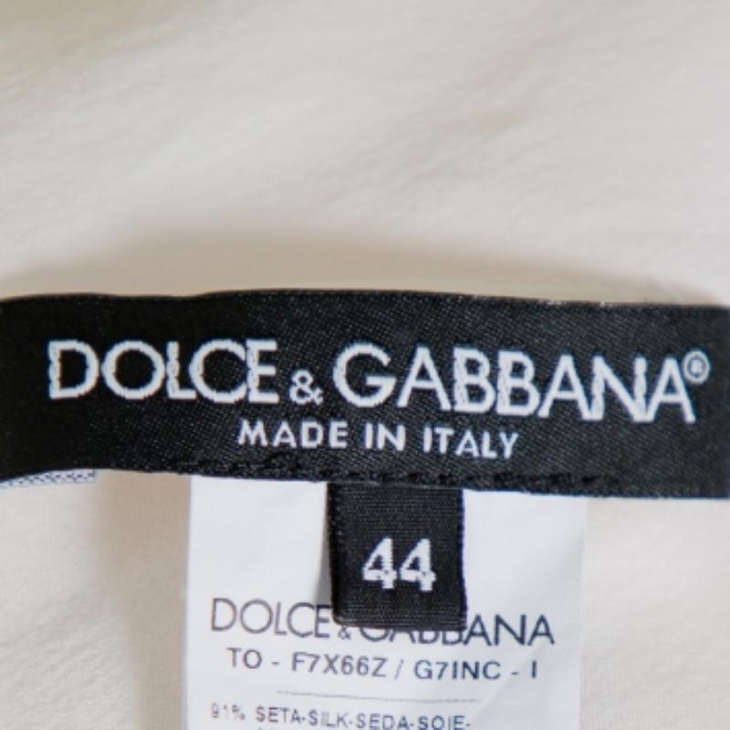 This Dolce & Gabbana blouse is just right to pair with both pants as well as skirts. It is made from a silk blend and detailed with sequin embellishments on the front. A round neckline and short sleeves complete this creation.