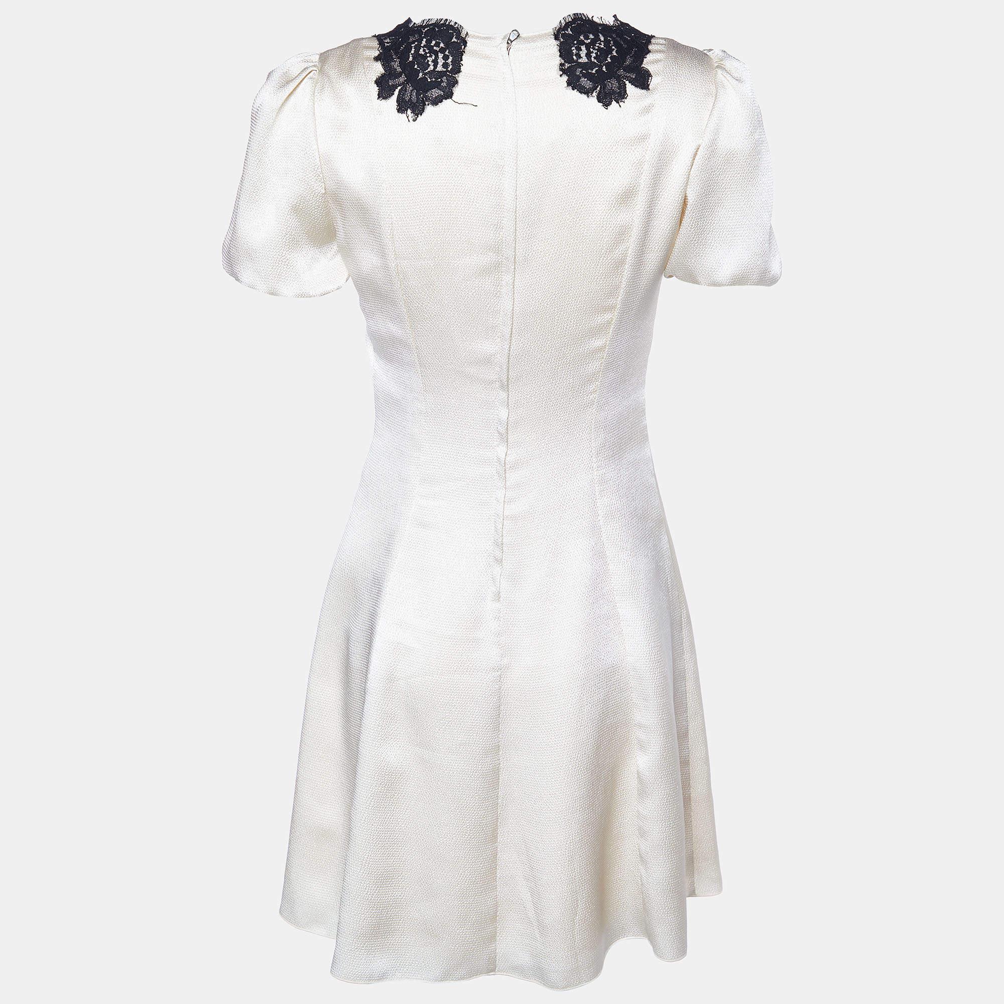 Get this mini dress that comes from the house of Dolce & Gabbana. This cream dress has been crafted from quality materials and is great for impromptu outings. This dress is styled with lace trims along the neckline. It is finished with zip closure.

