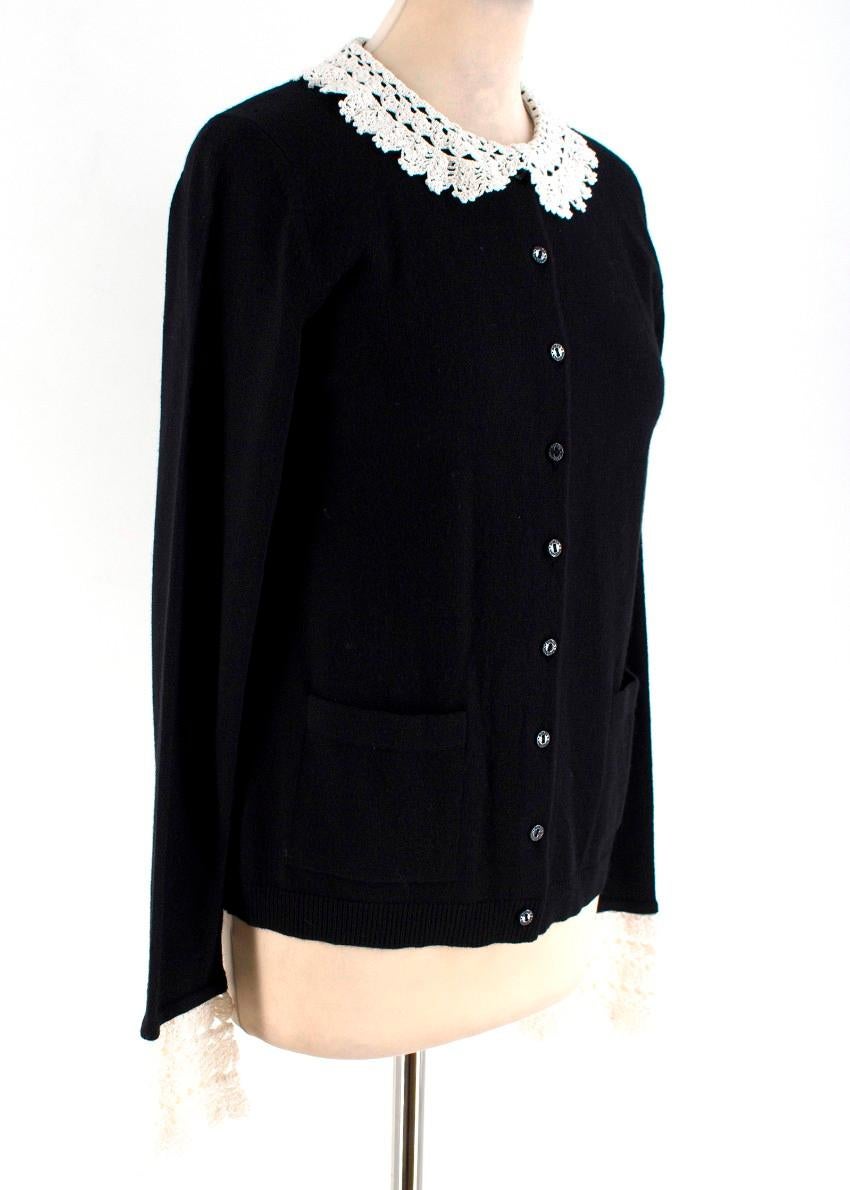 Dolce & Gabbana Crochet-Trimmed Cashmere Cardigan

- Black cashmere cardigan with off-white cotton crochet collar and cuff trimming
- Front slip pockets
- Branding embossed button fastening

Please note, these items are pre-owned and may show some