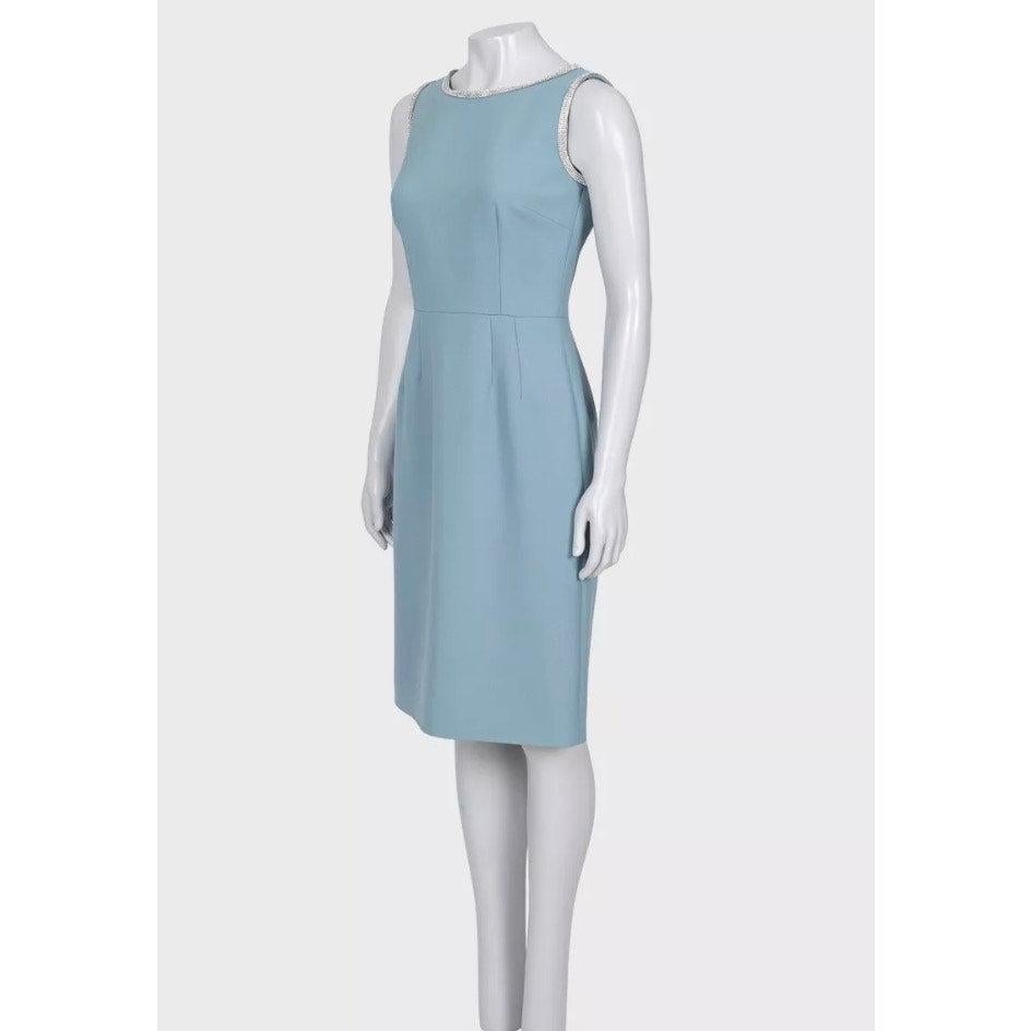 Elegant Dolce & Gabbana fitted dress in light blue. Crafted from high-quality virgin wool with stunning crystal embellishments. This dress features a tailored silhouette and a back zip closure. Perfect for special occasions or adding a touch of