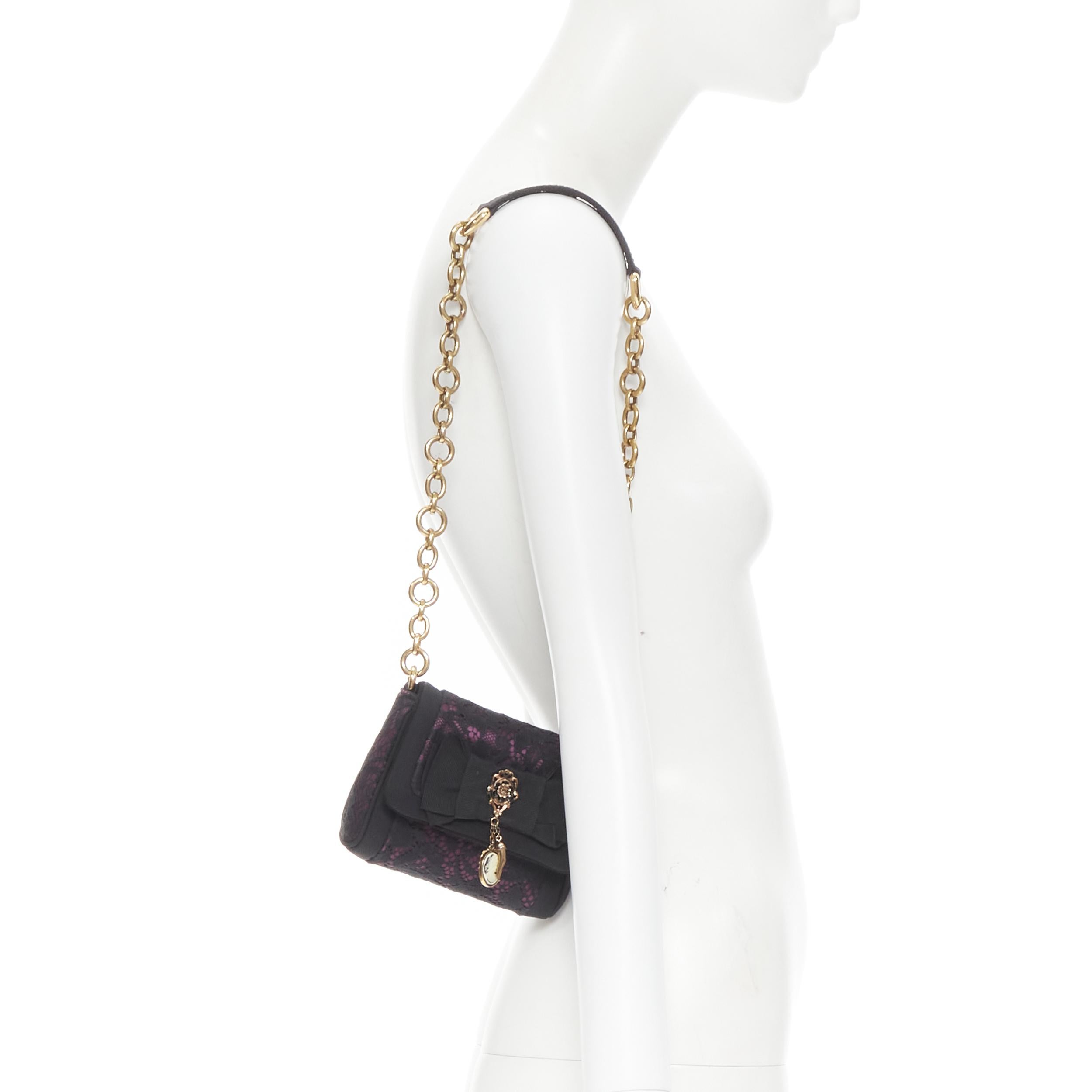 DOLCE GABBANA crystal medallion charm bow lace satin flap chain shoulder strap 
Reference: TGAS/B01388 
Brand: Dolce Gabbana 
Model: Black lace ribbon bag 
Material: Silk 
Color: Black 
Pattern: Floral 
Closure: Magnet 
Extra Detail: Lace covered