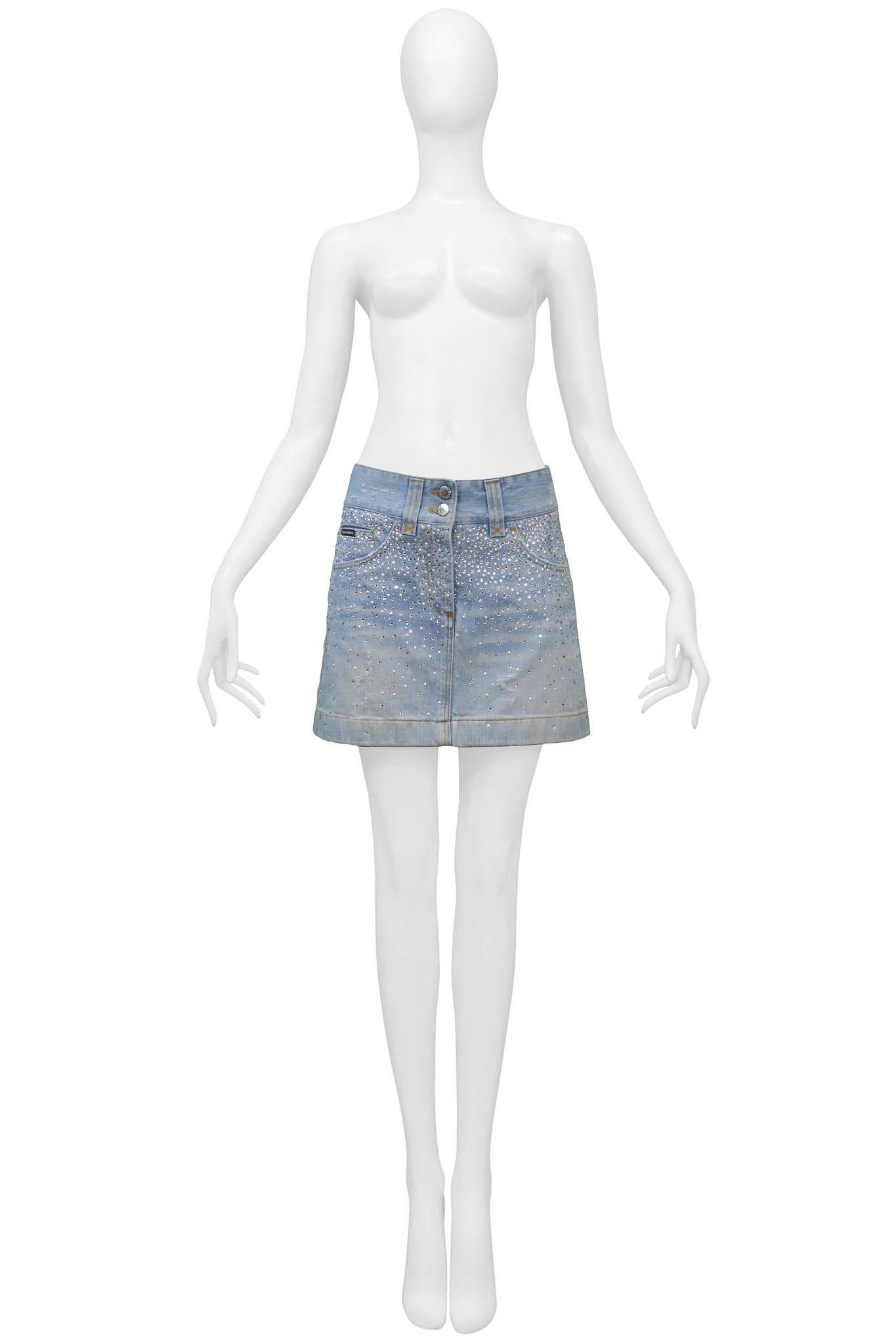 Resurrection Vintage is excited to offer a vintage Dolce & Gabbana denim mini skirt featuring yellow stitching, back patch pockets, and a rhinestone and pearl gradient on the front and back of the skirt.

Dolce & Gabbana
Size 38
Cotton
Excellent