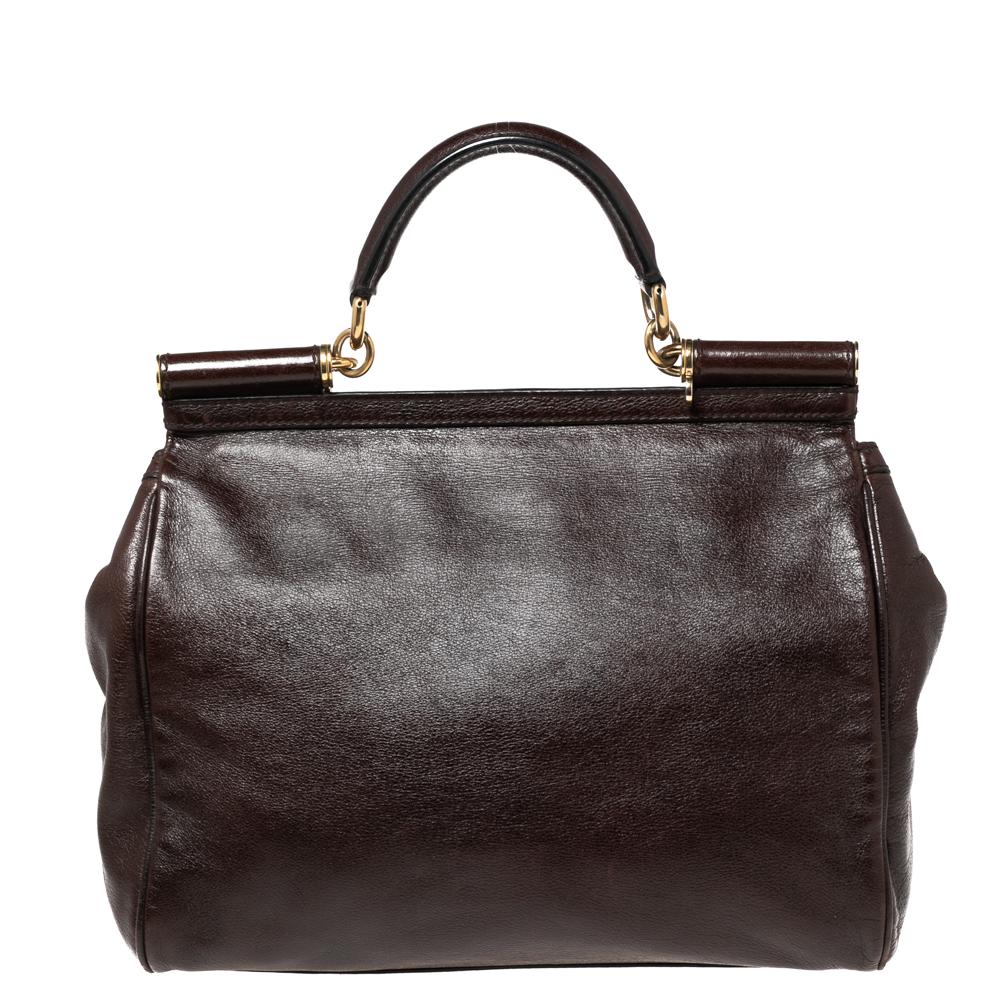 The iconic Miss Sicily bag by Dolce & Gabbana is one of the most loved designs from the brand. The elegant silhouette is made from leather in a dark brown shade and features a front flap accented with the logo plaque. The creation is complemented by