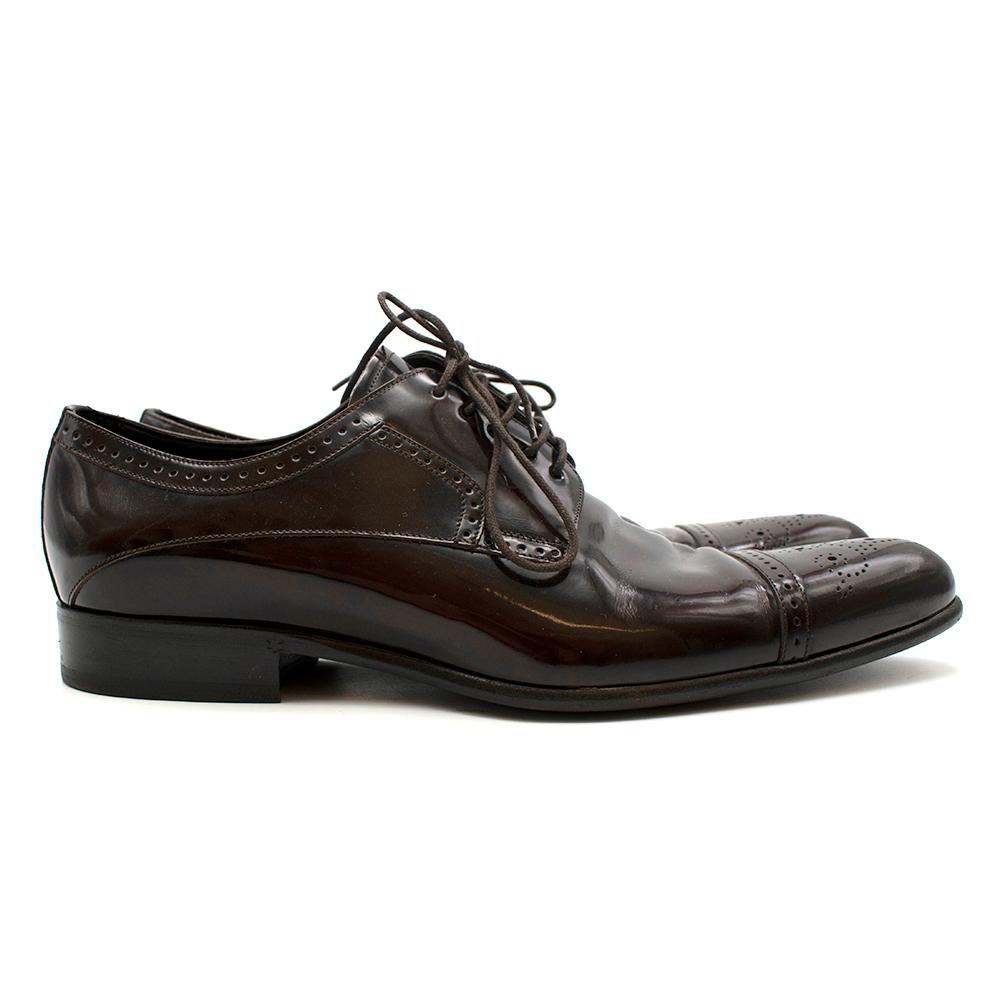 Dolce & Gabbana Dark Brown Patent Leather Derby Shoes

- Dark brown patent leather 
- Decorative derby style 
- Round toe 
- Lace-up fastening 
- Branded innersole 
- Low heel
- Decorative perforations 
- UK 10/ EU 44

Materials: 
100% Leather