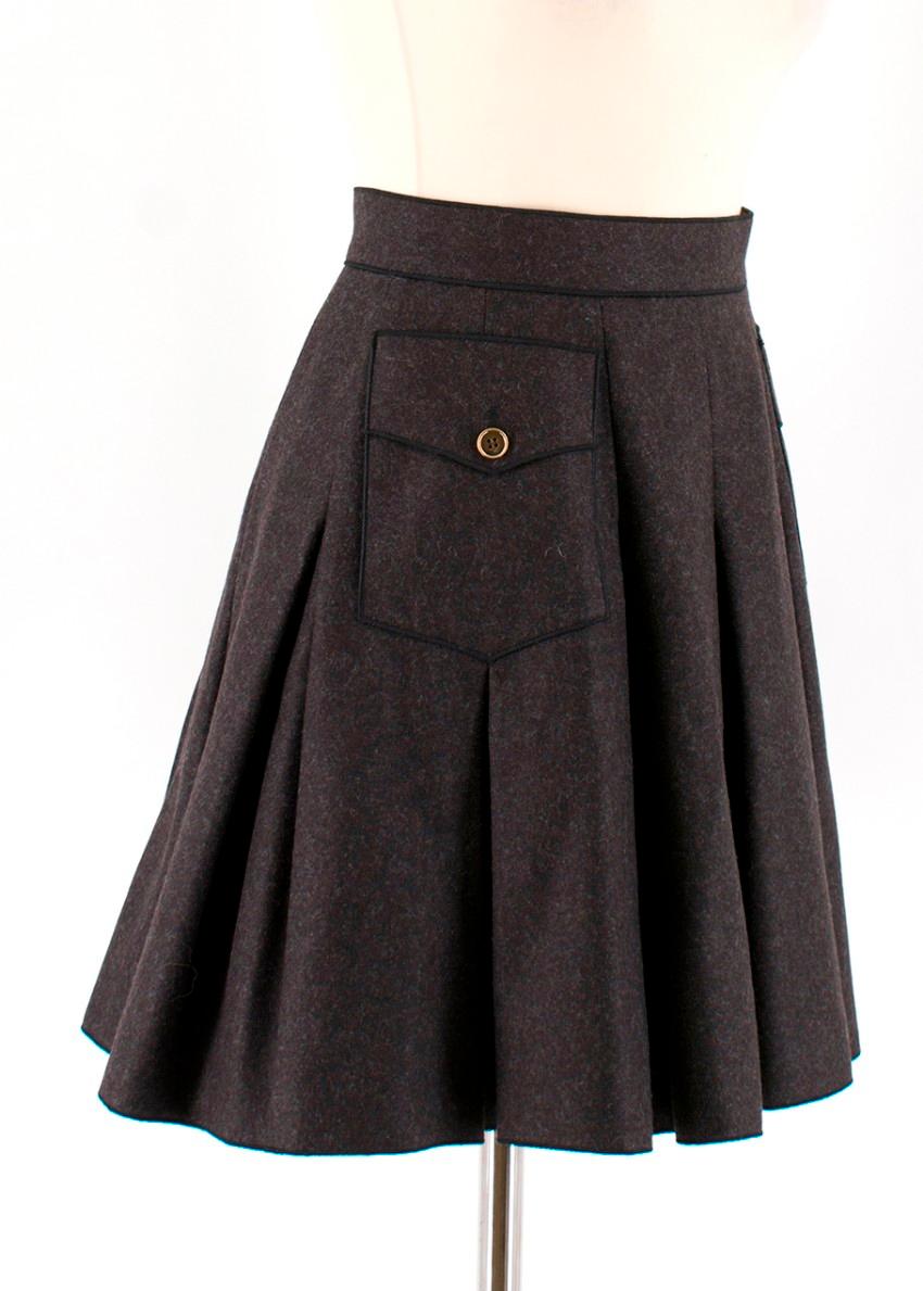Dolce & Gabbana Dark Grey Pleated Wool Skirt 

-Two pockets with button closure
-Pleated around skirt 
-Cheetah print rayon lining 
-Two snap buttons with zipper closure to the back 
Measurements are taken laying flat, seam to seam. 

Approx
Waist: