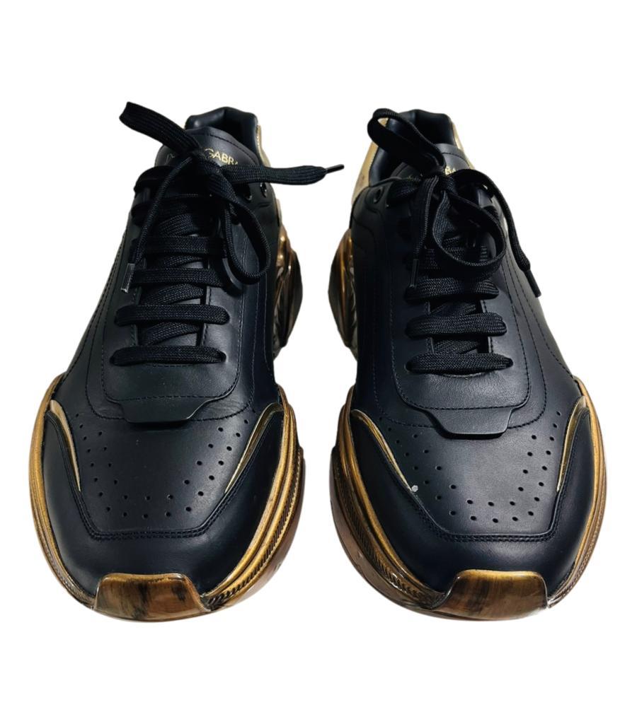 Dolce & Gabbana 'Daymaster' Leather Sneakers

Black, lace-up sneakers designed with perforations to the front.

Featuring gold platform with 'Dolce & Gabbana' logo to the heel and side.

Detailed with antiqued gold rubber soles decorated with