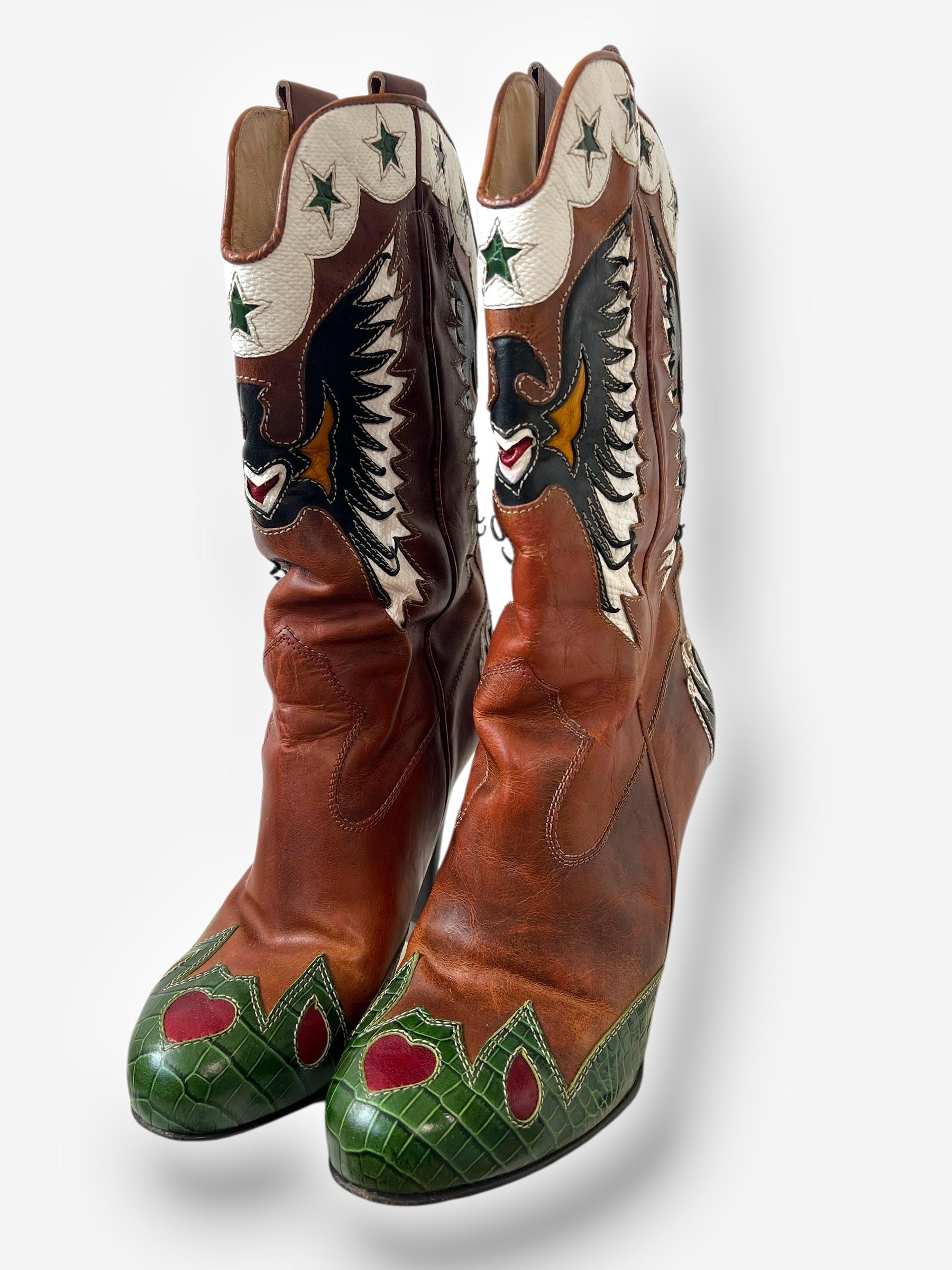A striking fusion of Western influences and high-fashion edge, these D&G cowboy boots feature a 4.5-inch stiletto heel that elevates their bold attitude. Crafted from rich brown leather, the boots showcase an intricate butterfly motif across the toe