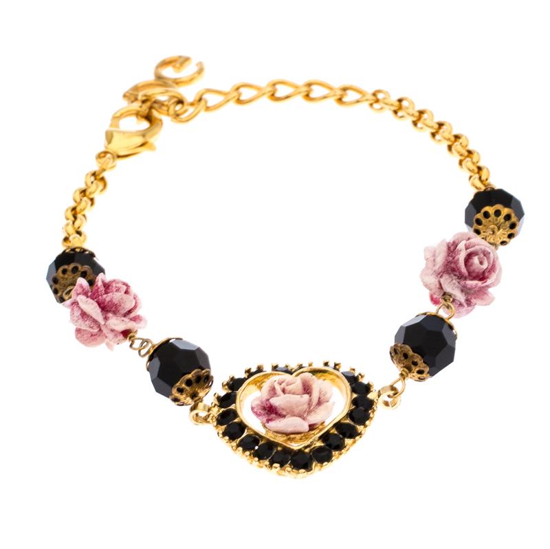 A bracelet that adds a touch of feminine charm to your outfit, this piece by Dolce & Gabbana is crafted from gold-tone metal. It features a string of pink roses and beads with a heart-shaped charm at the centre. The chain is equipped with a lobster