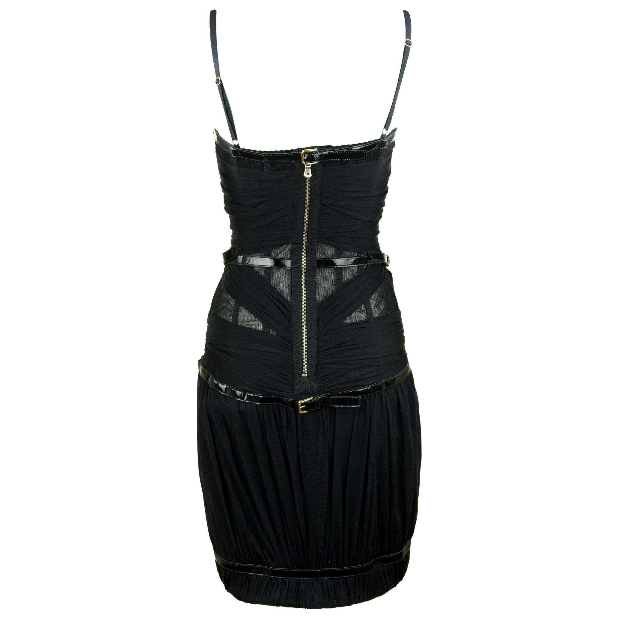 Dolce & Gabbana Black Bondage Corseted Bodycon Mini Dress has a built in corset with exposed zipper detail, sheer tulle with featured patent leather belt details.  

Size: IT 42

Care; Dry clean only

Made in Italy