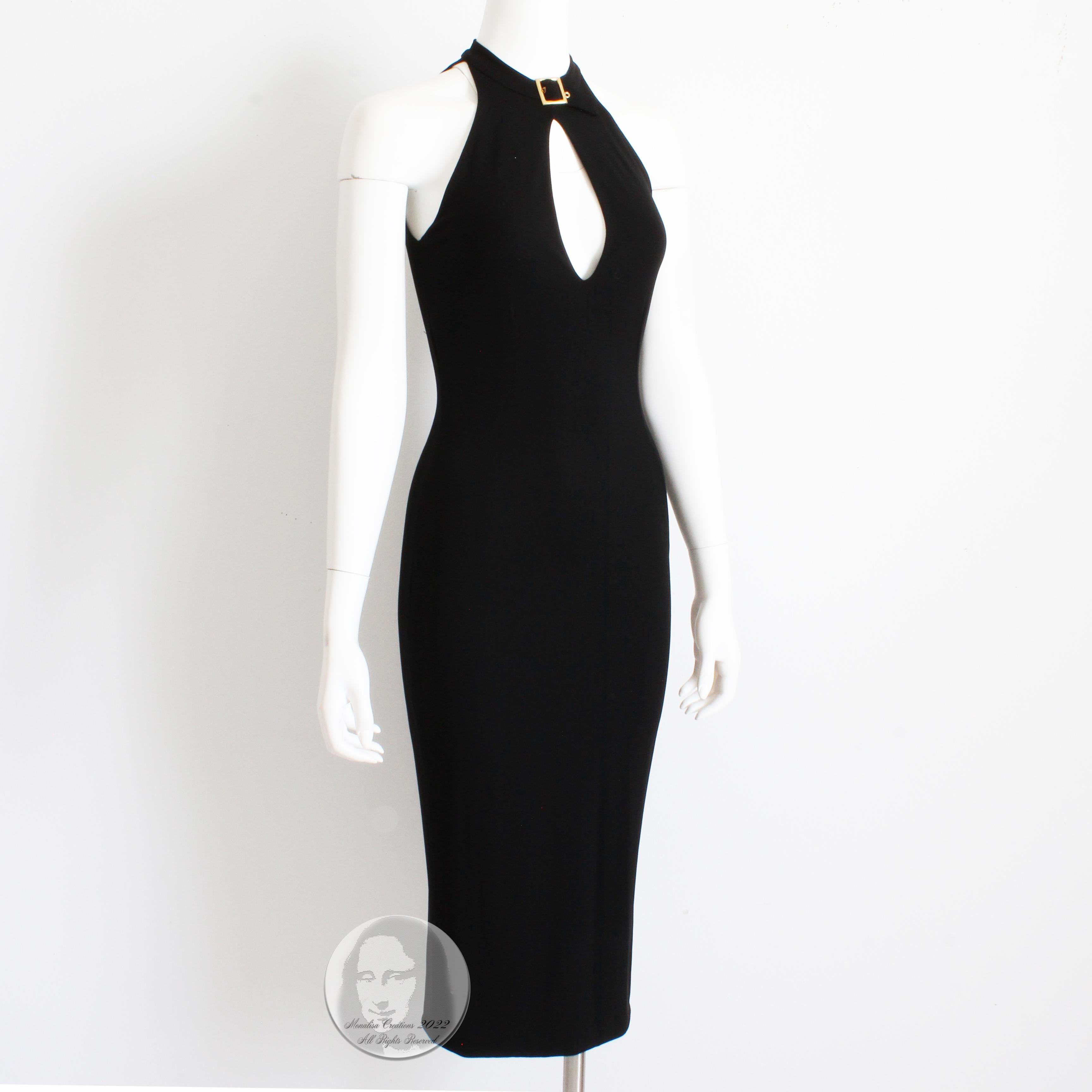 This chic black jersey dress was made by Dolce & Gabbana, most likely in the mid 1990s. Made from what we suspect is a viscose/elastane blend (no content label), the cut and construction on this dress is so sexy and sophisticated! It features a gold
