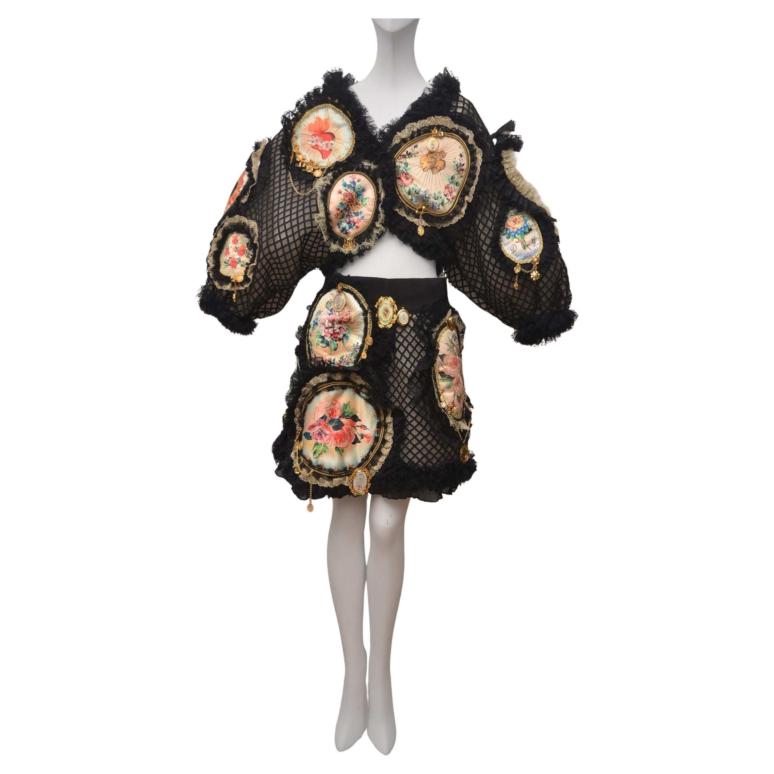 Dolce & Gabbana Embellished Set Skirt/Bolero Jacket  
Size 40 IT 
Embellished with chain,angels,hearths ,clover and crystals 
Lined in neutral mesh fabric 
Made in Italy.Very rare piece 
Very good condition.
Final sale. 
