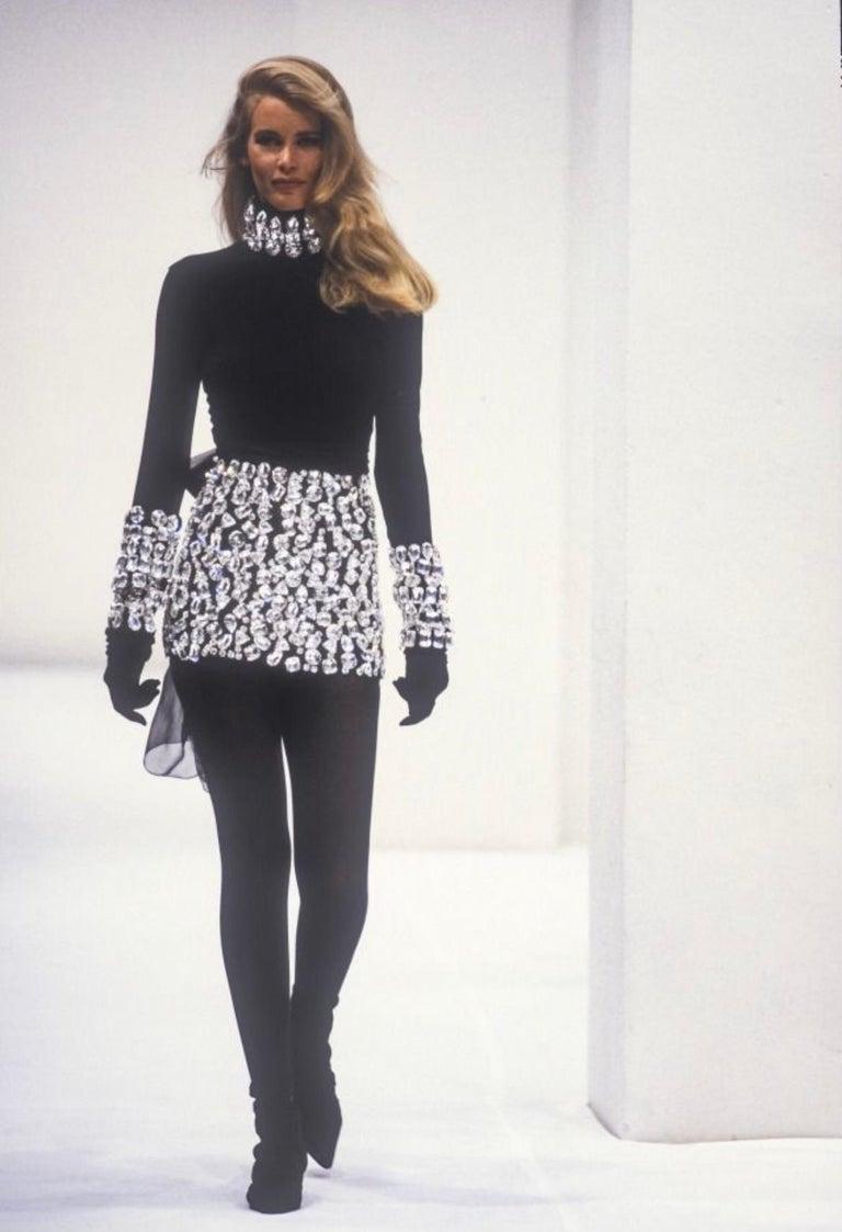 Stunning Dolce & Gabbana sweater from the iconic fall winter 1991 collection. This wool sweater features faux crystals which are attached to the collar and sleeves of the garment. The sweater is in great condition, only missing one of the crystals