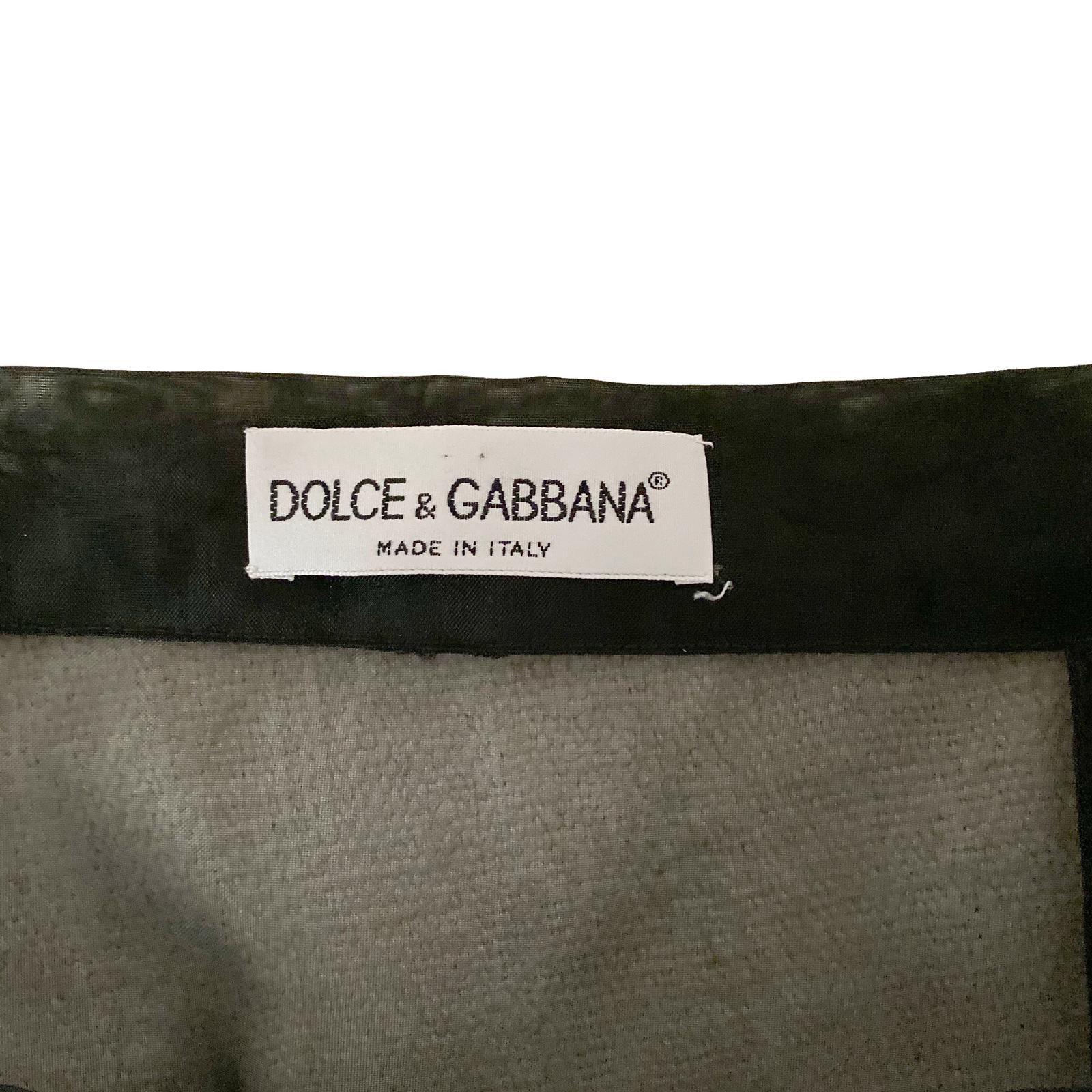 Dolce & Gabbana F/W 95 Black knee-length sheer skirt with double teal fur trim, also showcased at the 1995 edition of “Donna sotto le Stelle” in Rome.
Size IT 42
Measurements:
waist: 69 cm/ 27 inch 
length : 53 cm/ 21 inch

100% Polyamide Nylon 100%