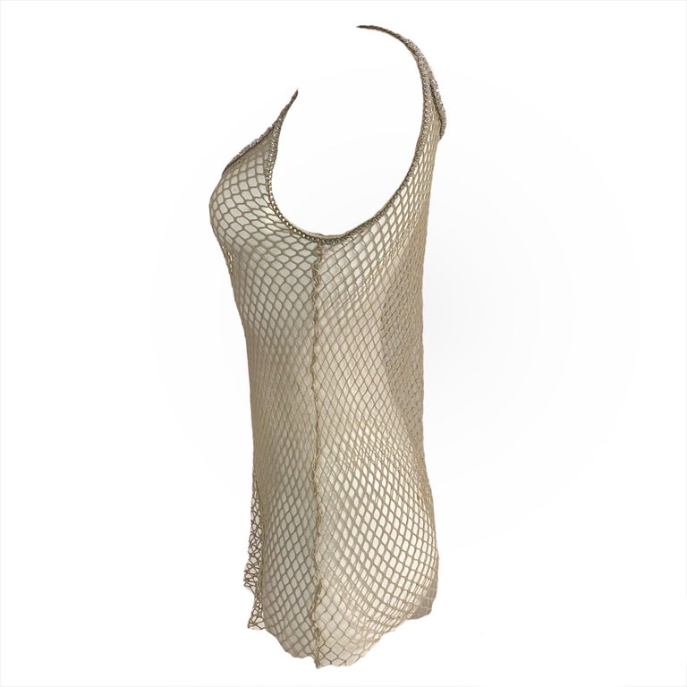 Dolce & Gabbana tan fishnet tank top with Swarovski rhinestones on collar and straps. Famously seen on Jennifer Lopez in the “Jenny from the block” music video.

Size 42

Pit to pit: 40 cm / 15.7 inch
Length (from strap): 69 cm / 27.1 inch