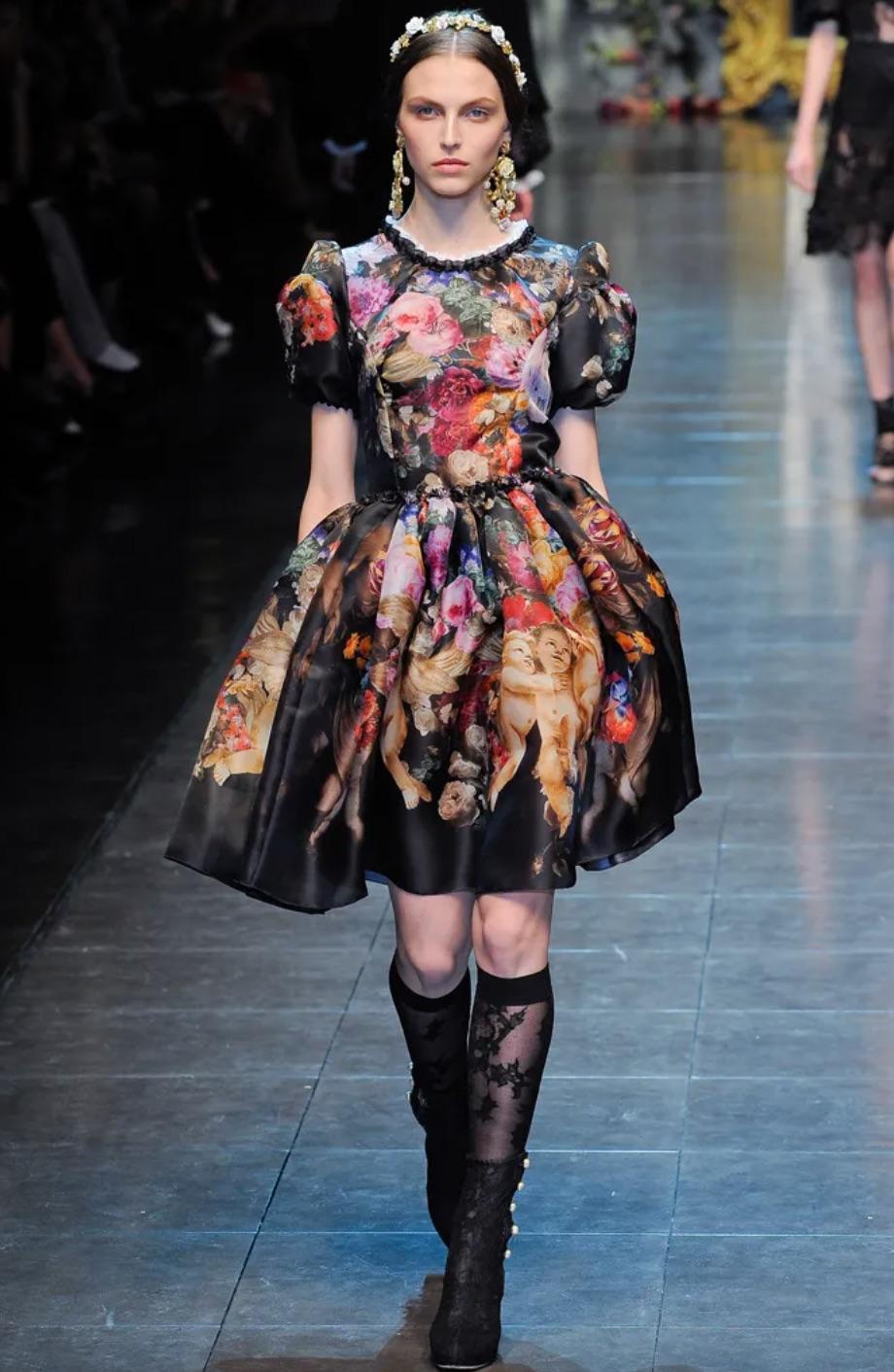 The Dolce & Gabbana cherub dress from their Fall/Winter 2012 collection is one of the brand's most wanted and recognizable piece of the last decade. The iconic multicolor print features cherubs and florals and is truly a work of art. The short
