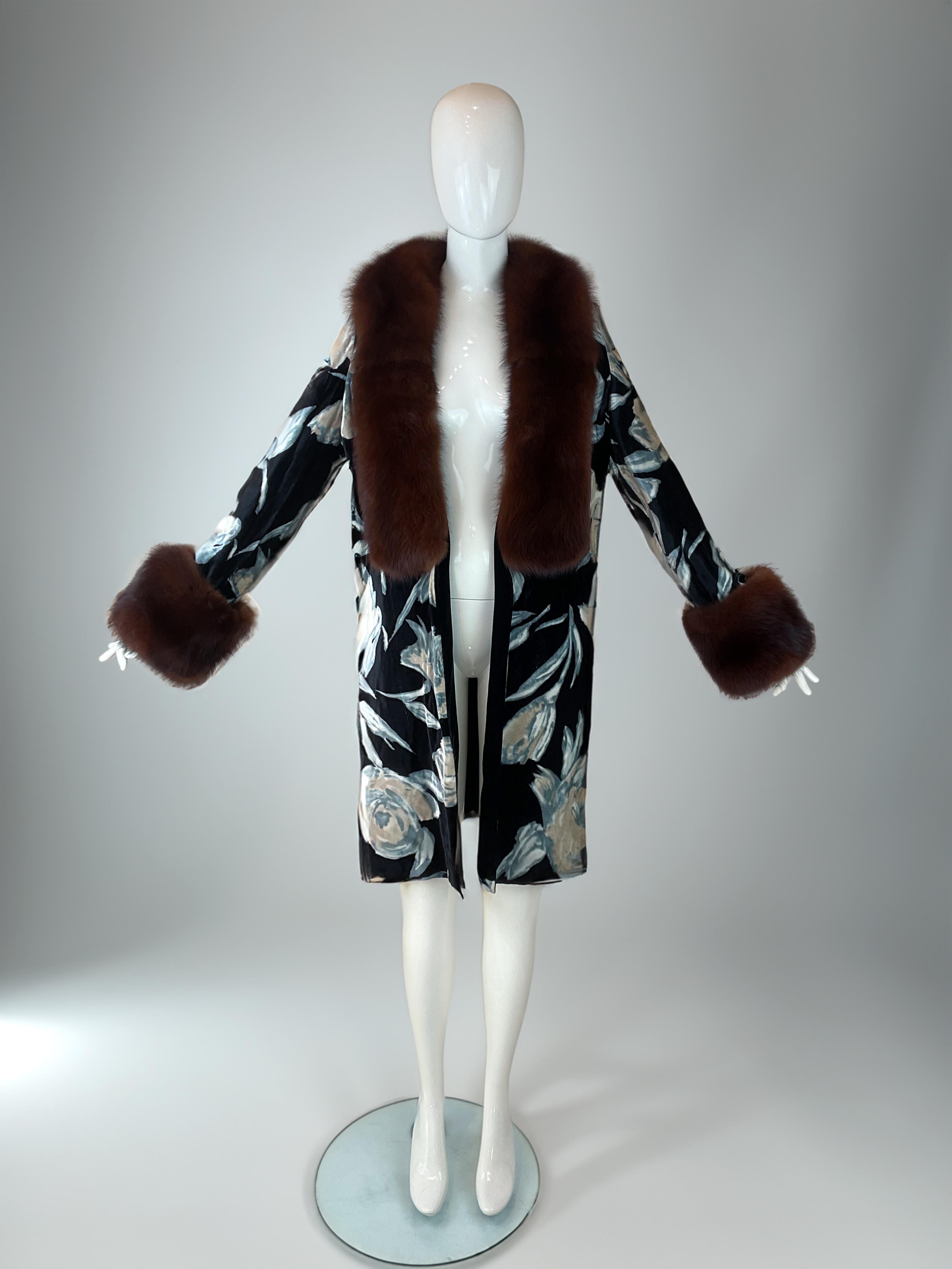 Dolce & Gabbana 1997 Velvet Coat with Fox Fur Trim

Rare Dolce & Gabbana coat from the Fall 1997 collection. Made of thick black velvet with large floral print in pale blue and beige tones. Features wide fox fur collar and cuffs in deep brown, and
