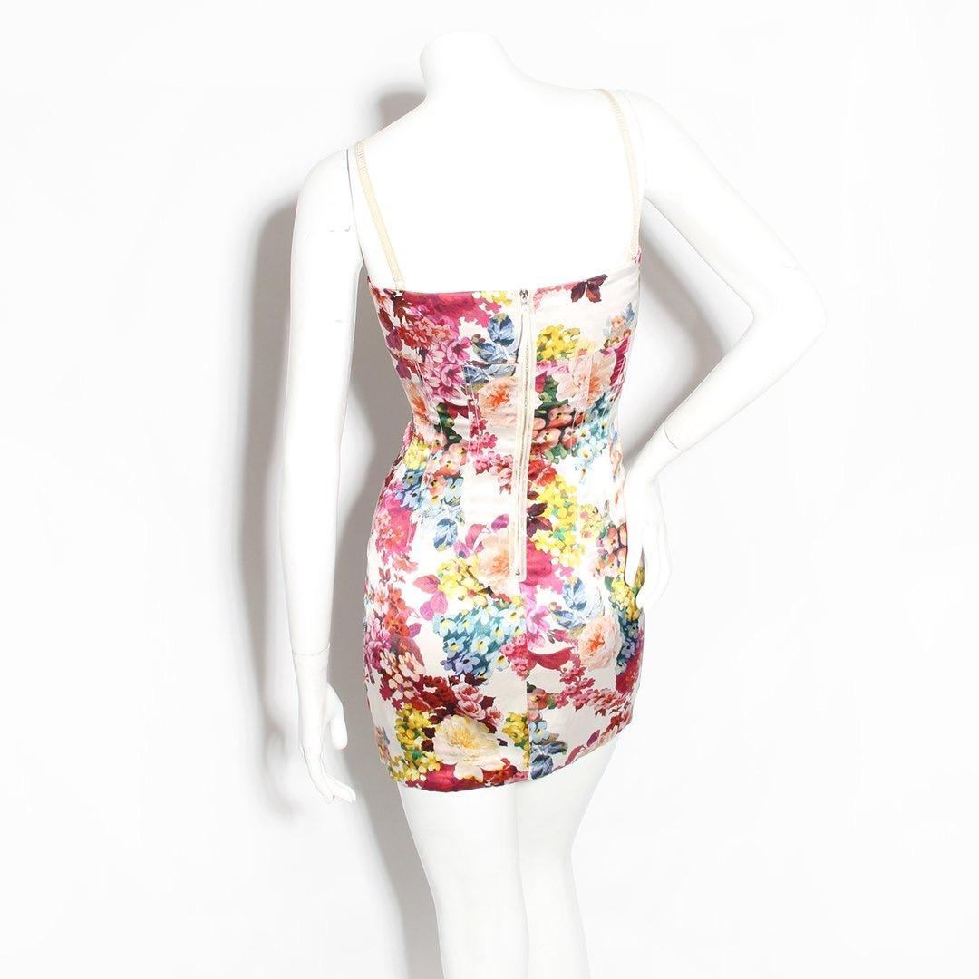 Floral mini dress by Dolce and Gabbana 
Circa 2011
Floral print 
Folded top hem 
Elastic spaghetti straps (adjustable) 
Decorative seams 
Zip back with hook and eye closure
93% silk, 7% elastane
Made in Hungary 
Condition: Excellent, small stain on