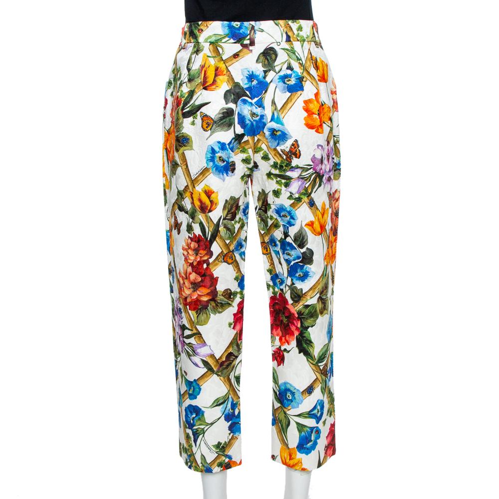 Dolce & Gabbana does not shy away from bold prints, and that is reflected in these stunning pants. The floral blooms printed on them express the romantic DNA of the label. Shaped to a high-rise silhouette with straight legs cropped at the ankles,